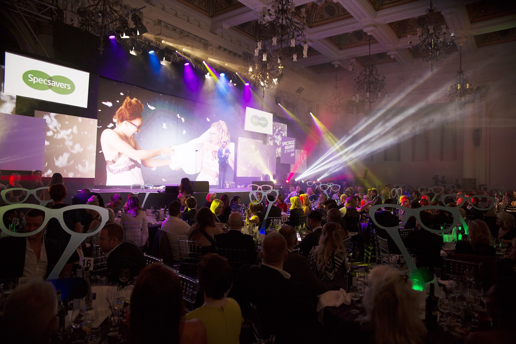 Vibrant corporate event at 8 Northumberland Avenue with engaging presentation and colorful lights.