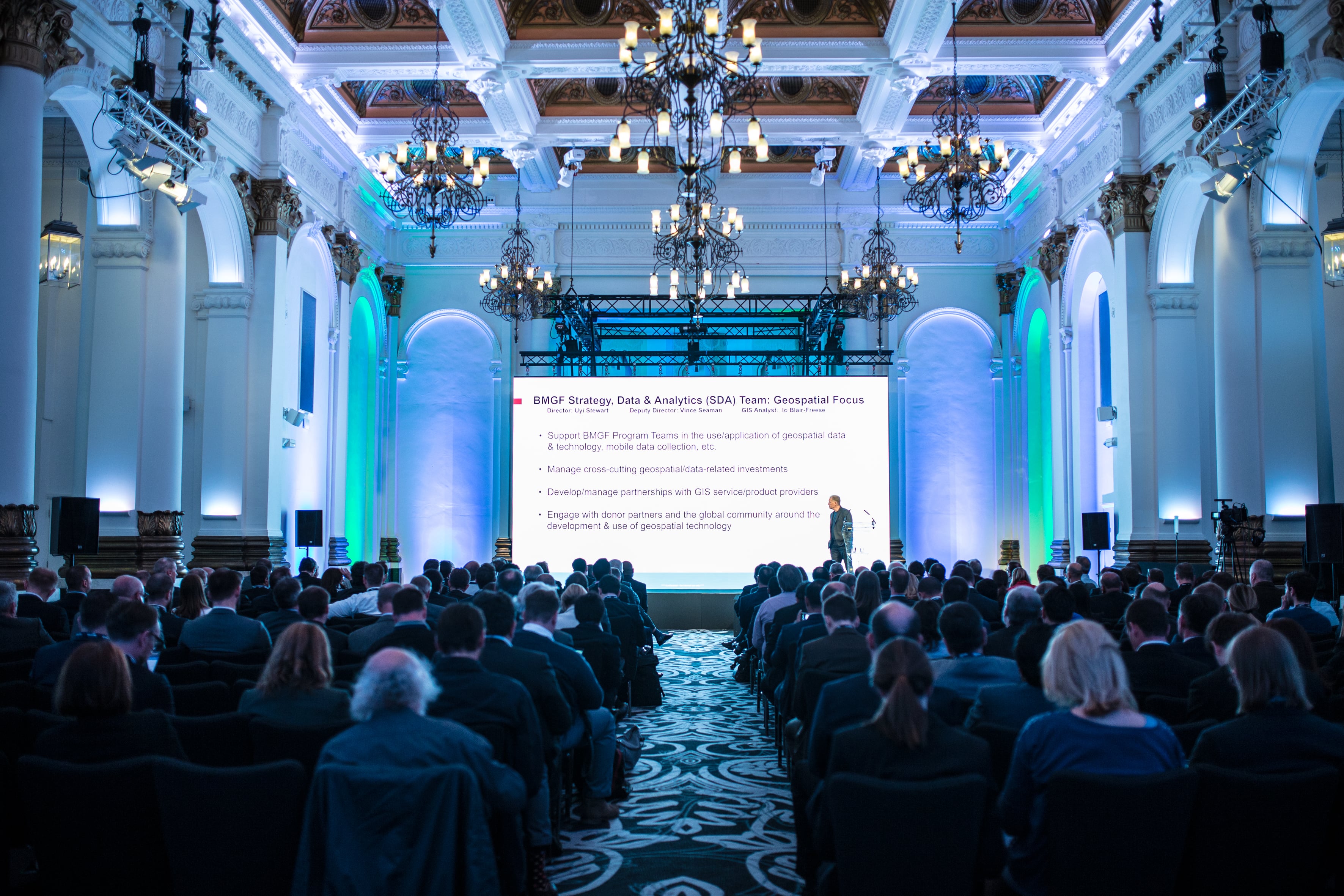 Elegant conference venue with high ceilings and engaged audience at 8 Northumberland Avenue.