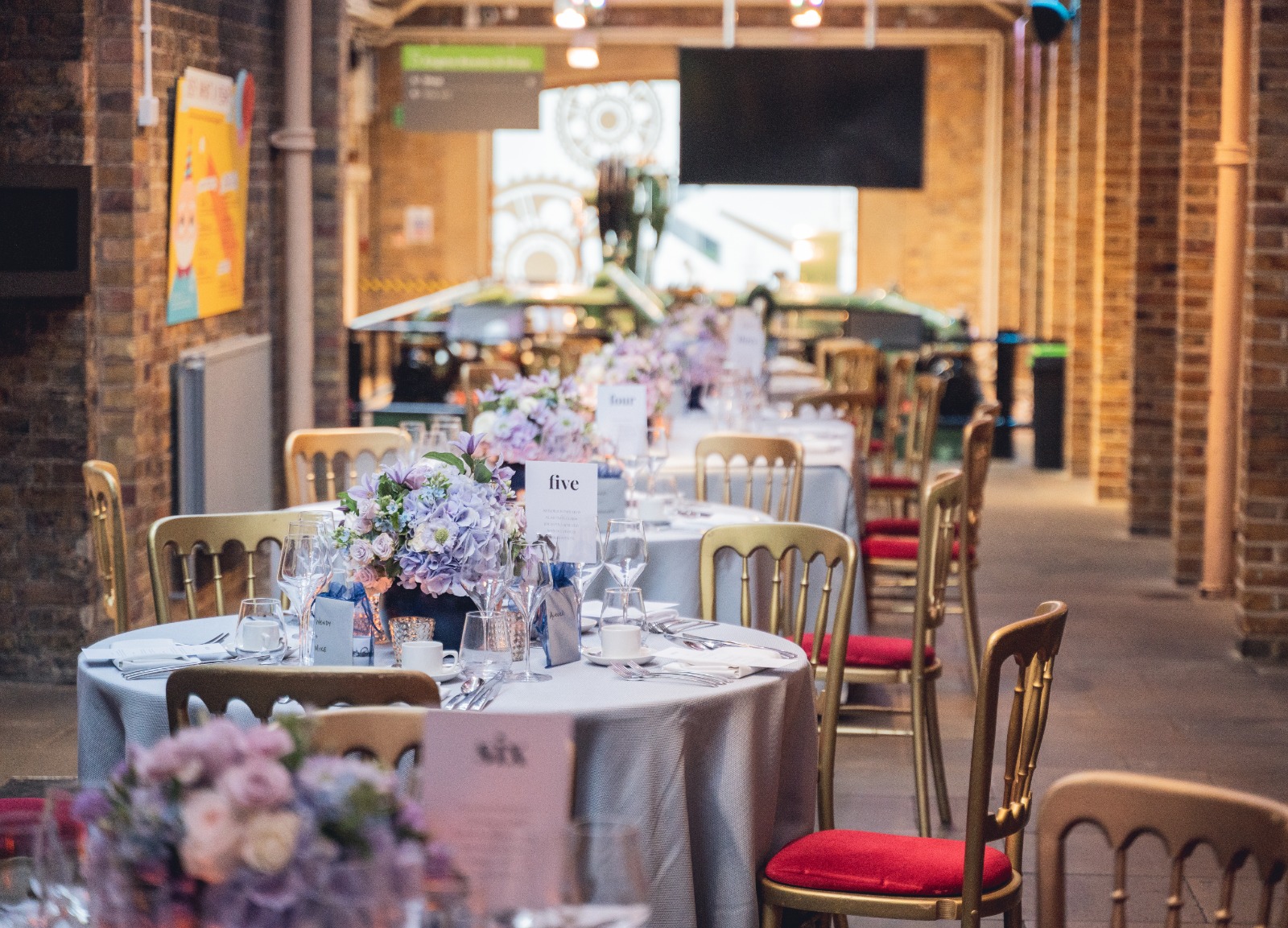 Elegant event space in Tower Bridge with floral centerpieces, perfect for corporate gatherings.