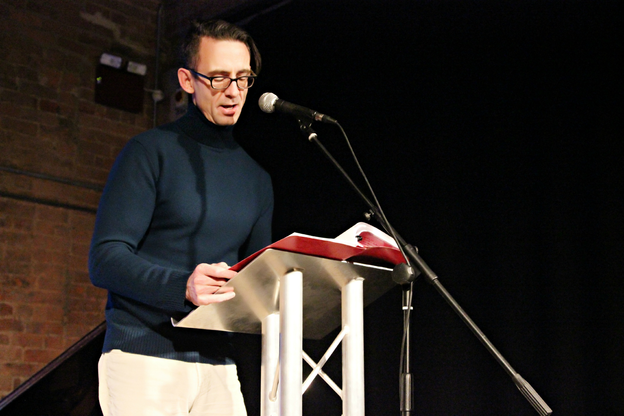 Speaker at podium in The Engine House, engaging audience during a professional event.