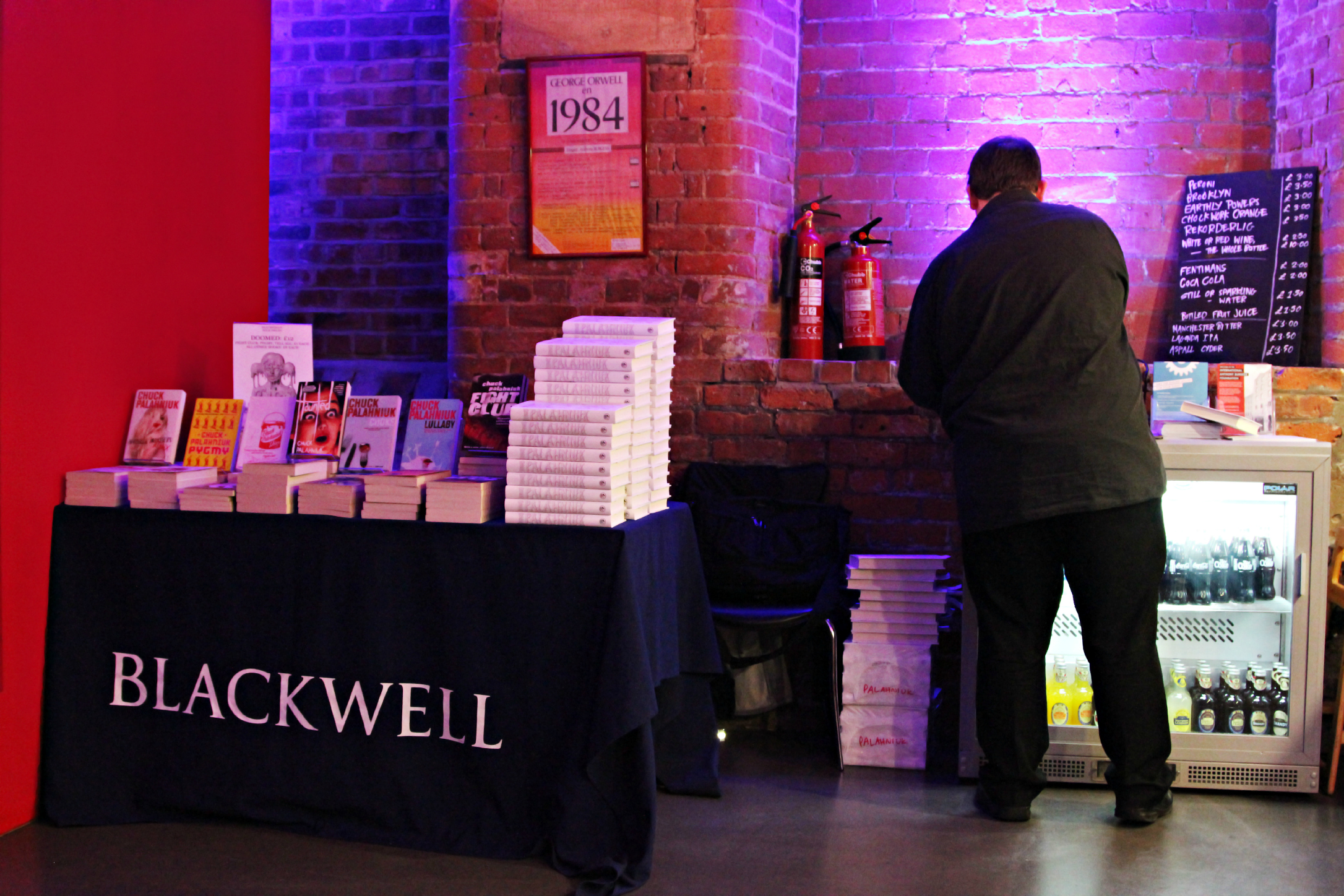 Event space at The Engine House with books, exposed brick, and refreshments for literature events.