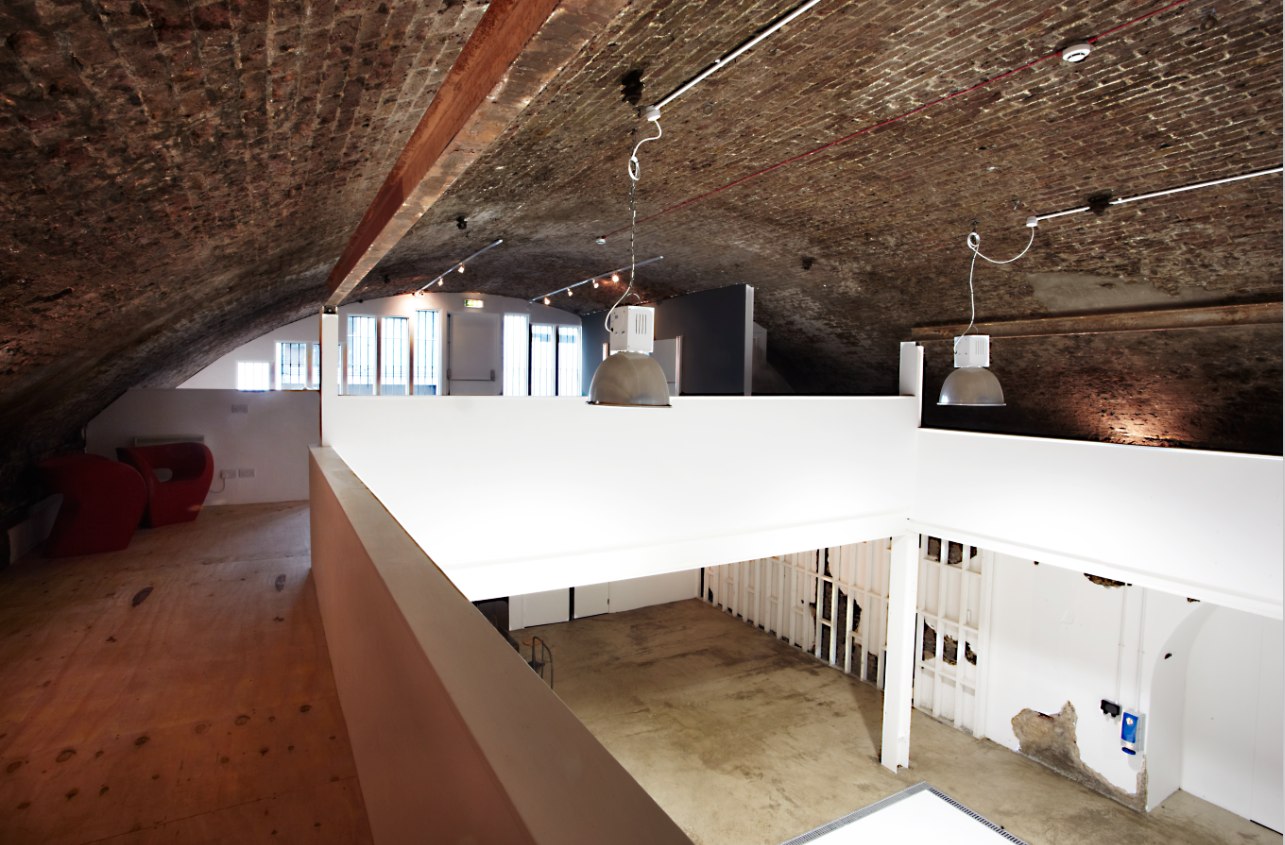 Event space Studio 2 with exposed brick and arching ceilings for unique gatherings.