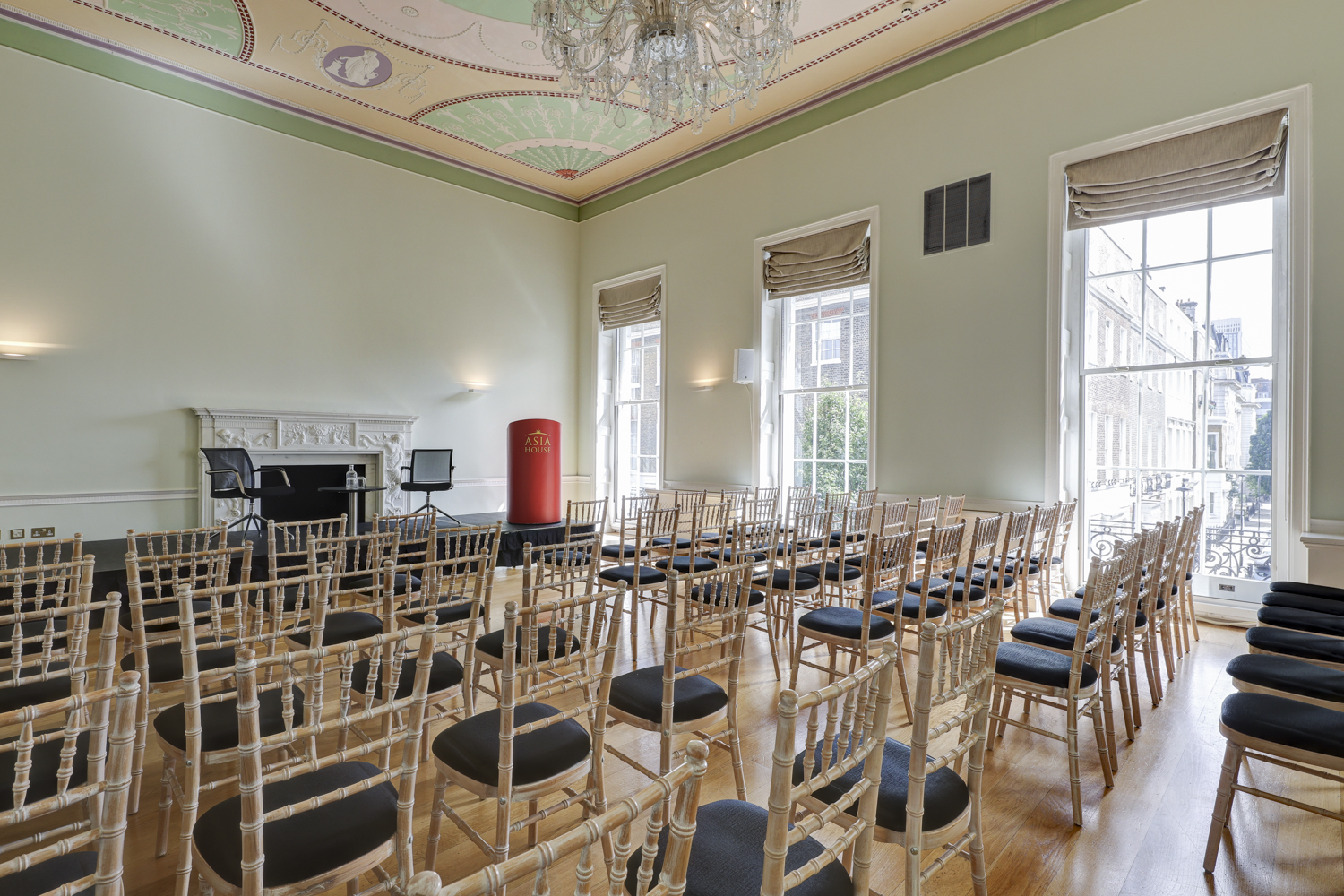 Elegant event space with wooden flooring, ideal for meetings and presentations.