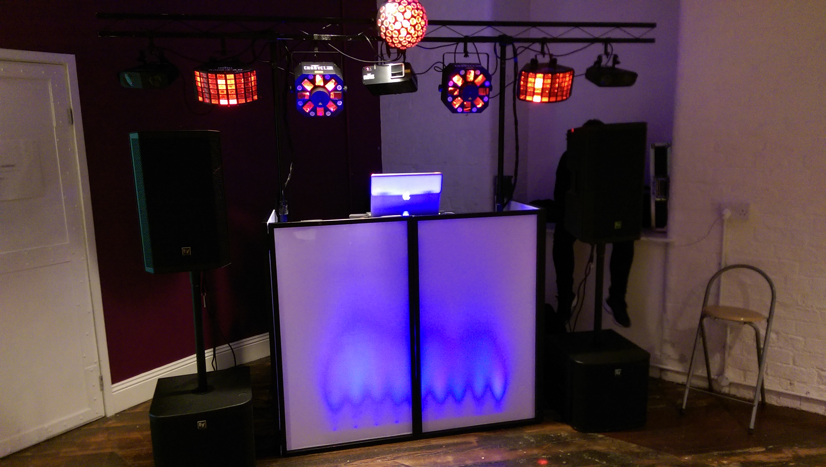 DJ booth with vibrant lighting at Exclusive Venue Hire for parties and corporate events.