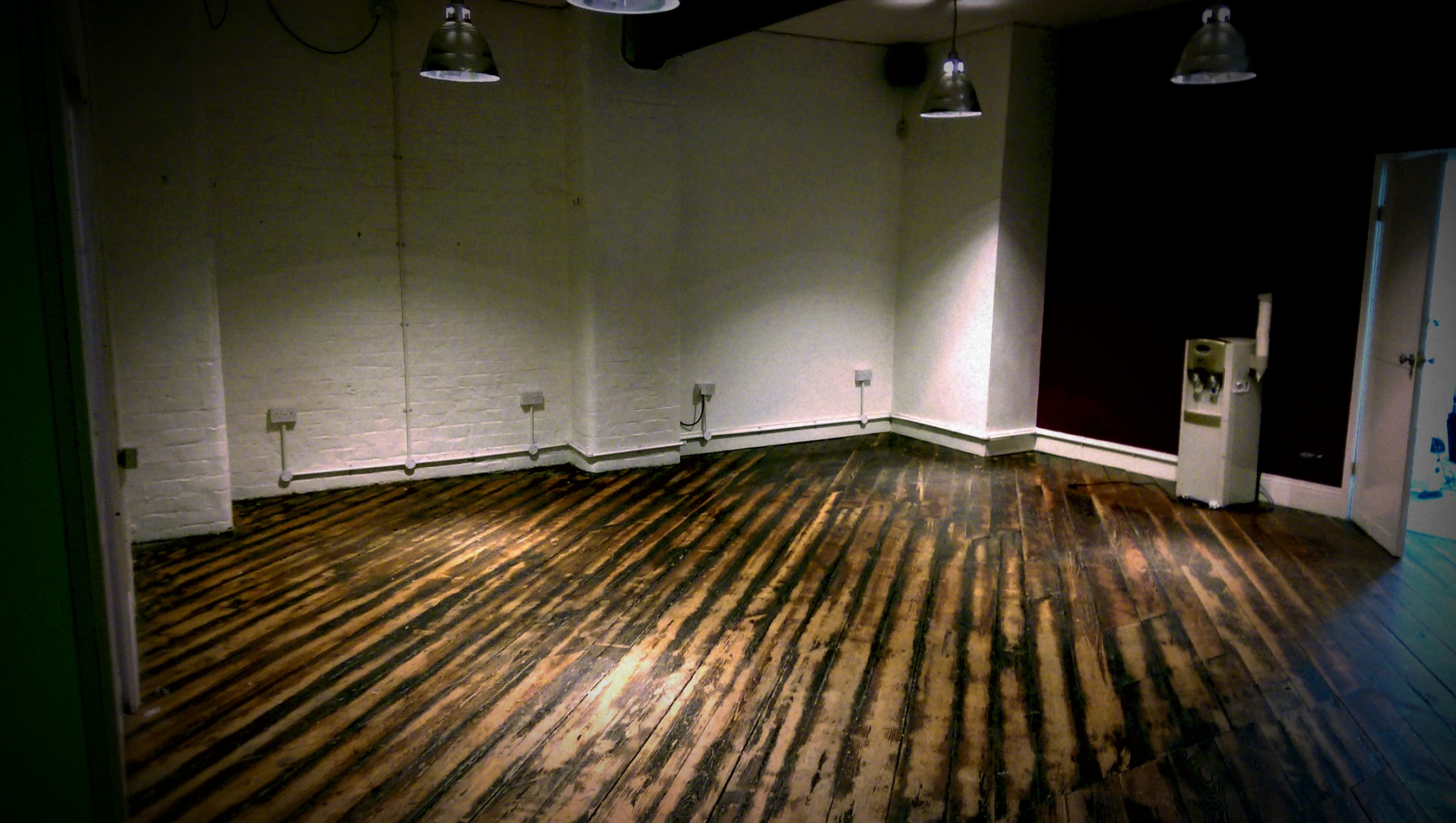 Versatile event space with rustic wooden floor for workshops and networking at 47 Dale Street.