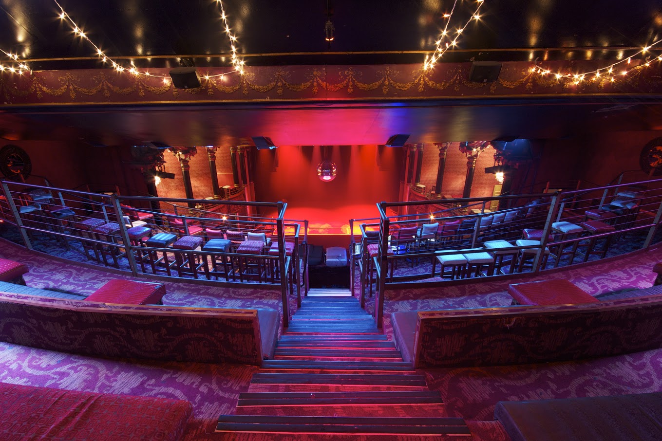 Stylish tiered seating venue with warm lighting for events and gatherings.