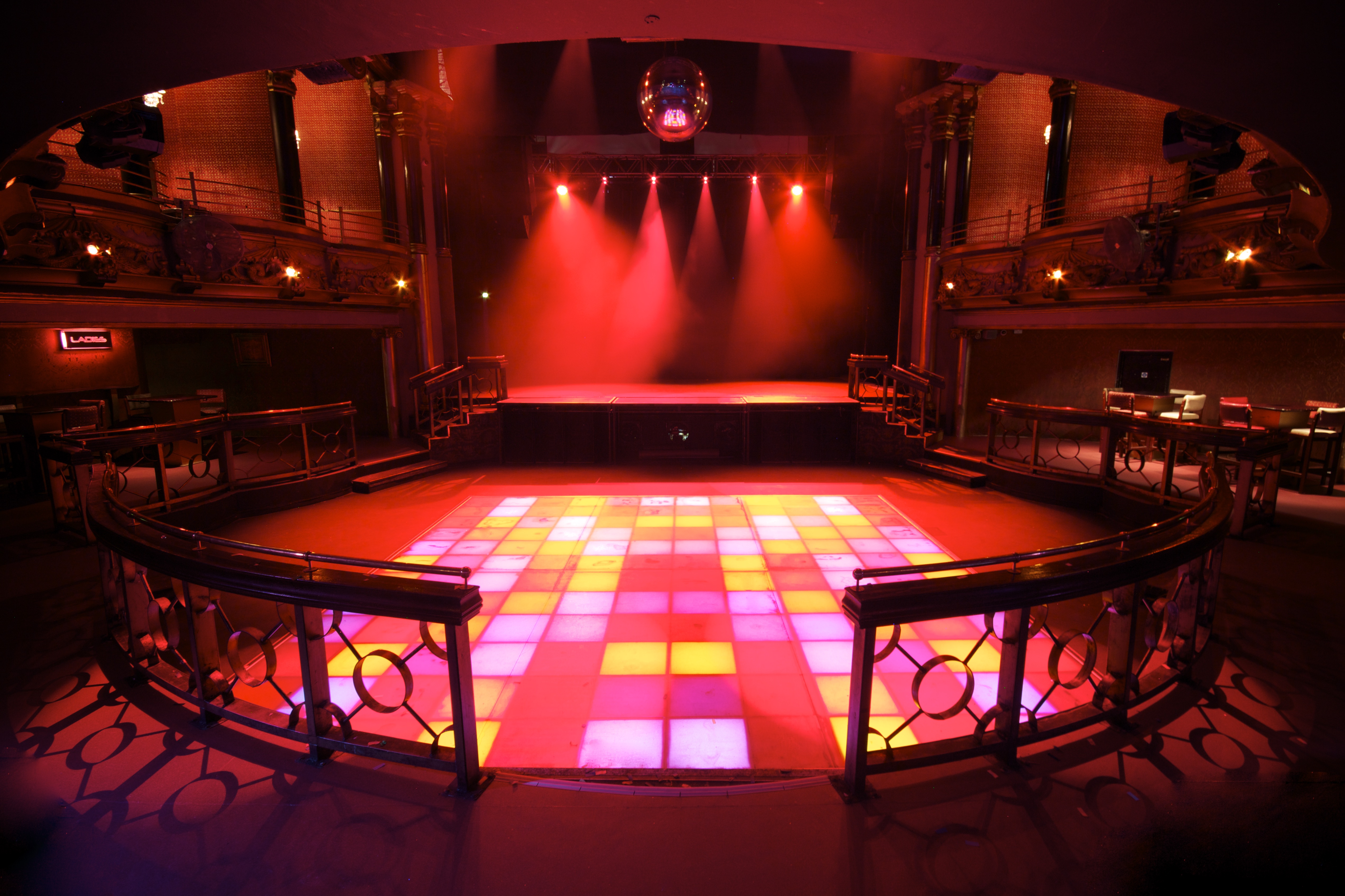Vibrant event space with colorful dance floor, ideal for corporate events and parties.