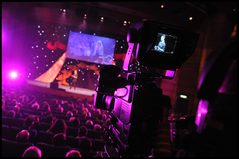 Pentland Auditorium event setup with speaker, audience, and vibrant lighting.