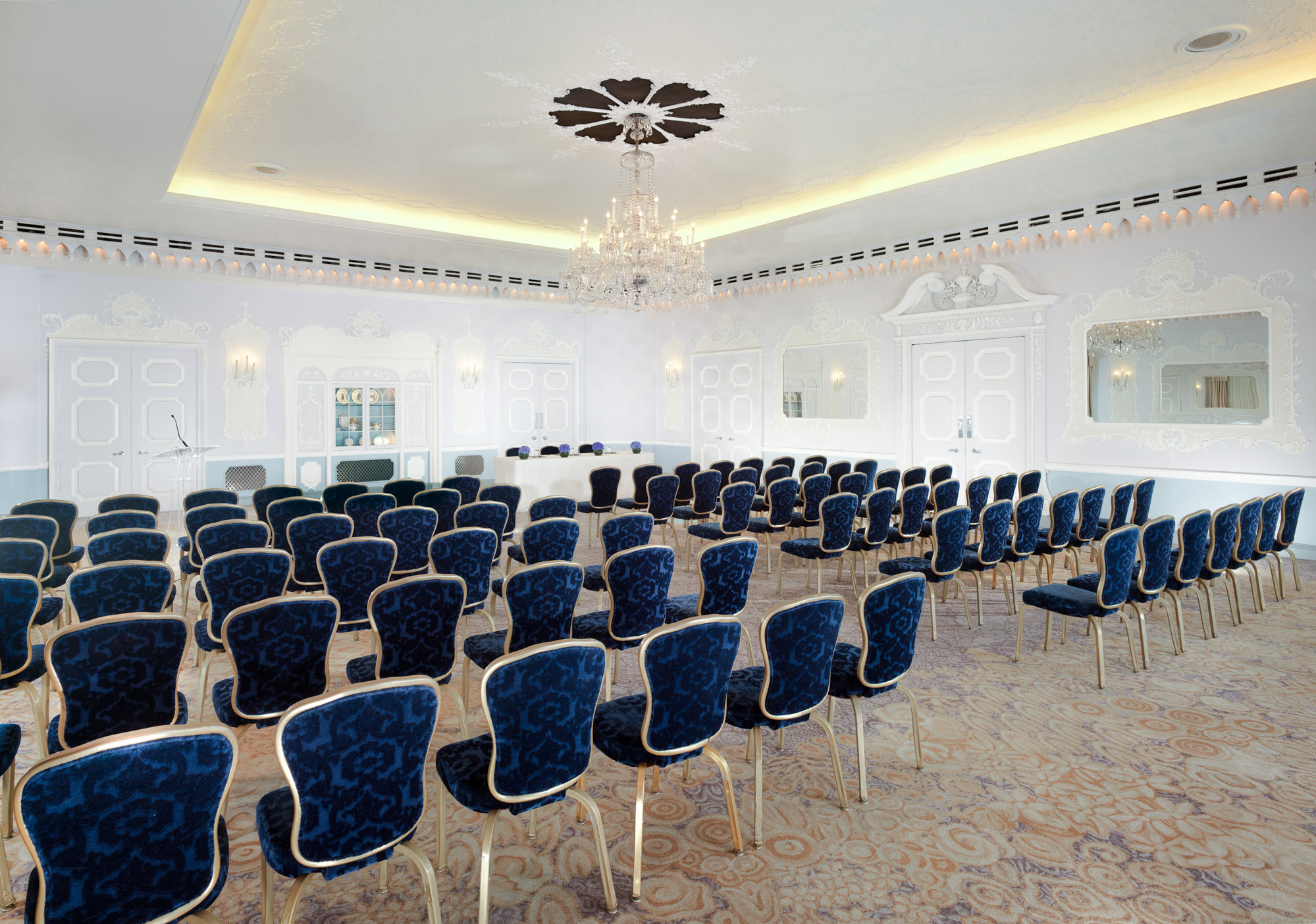 Sophisticated conference room with blue chairs, ideal for meetings and workshops.