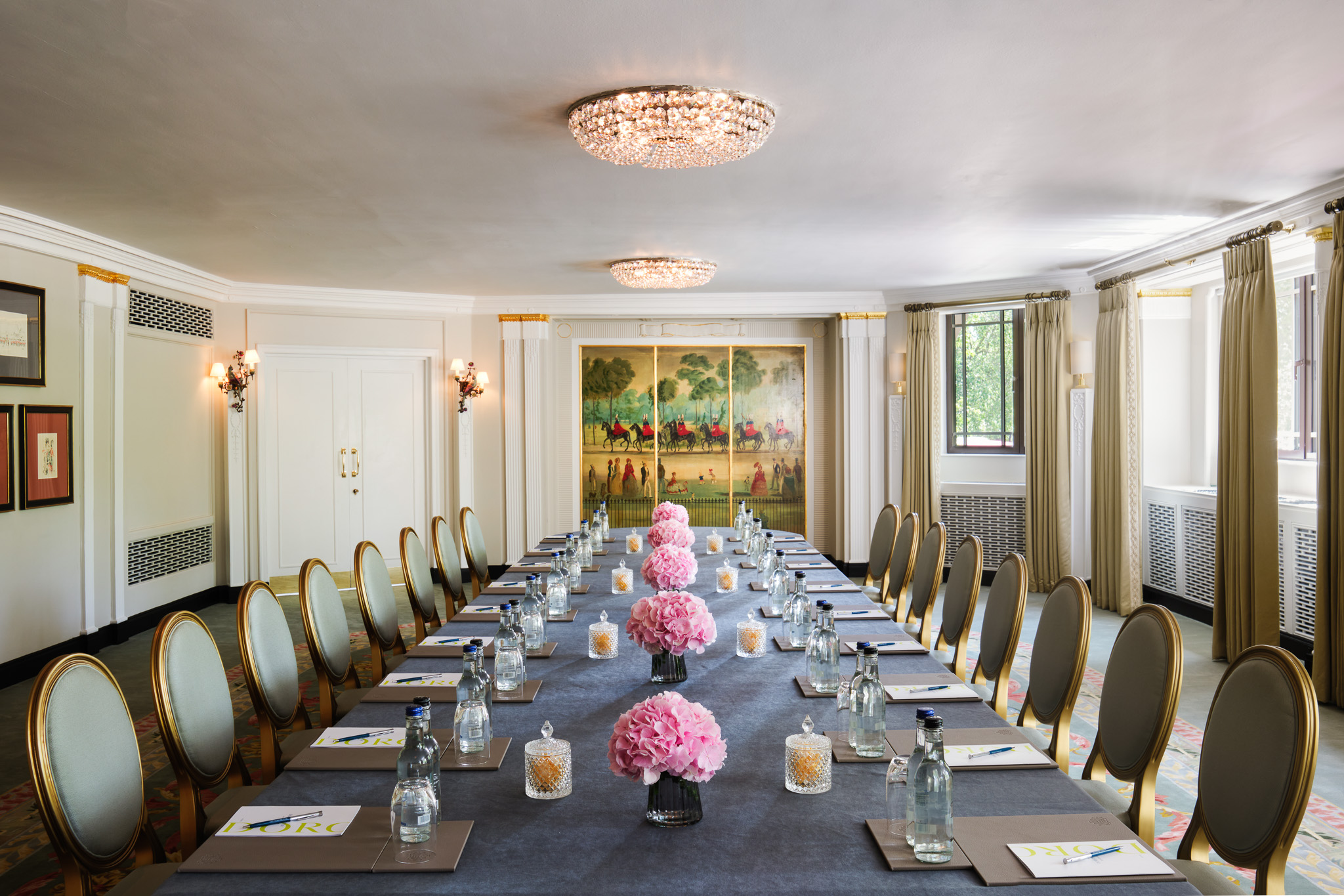 Elegant Park Suite meeting room with floral centerpieces, perfect for corporate events.