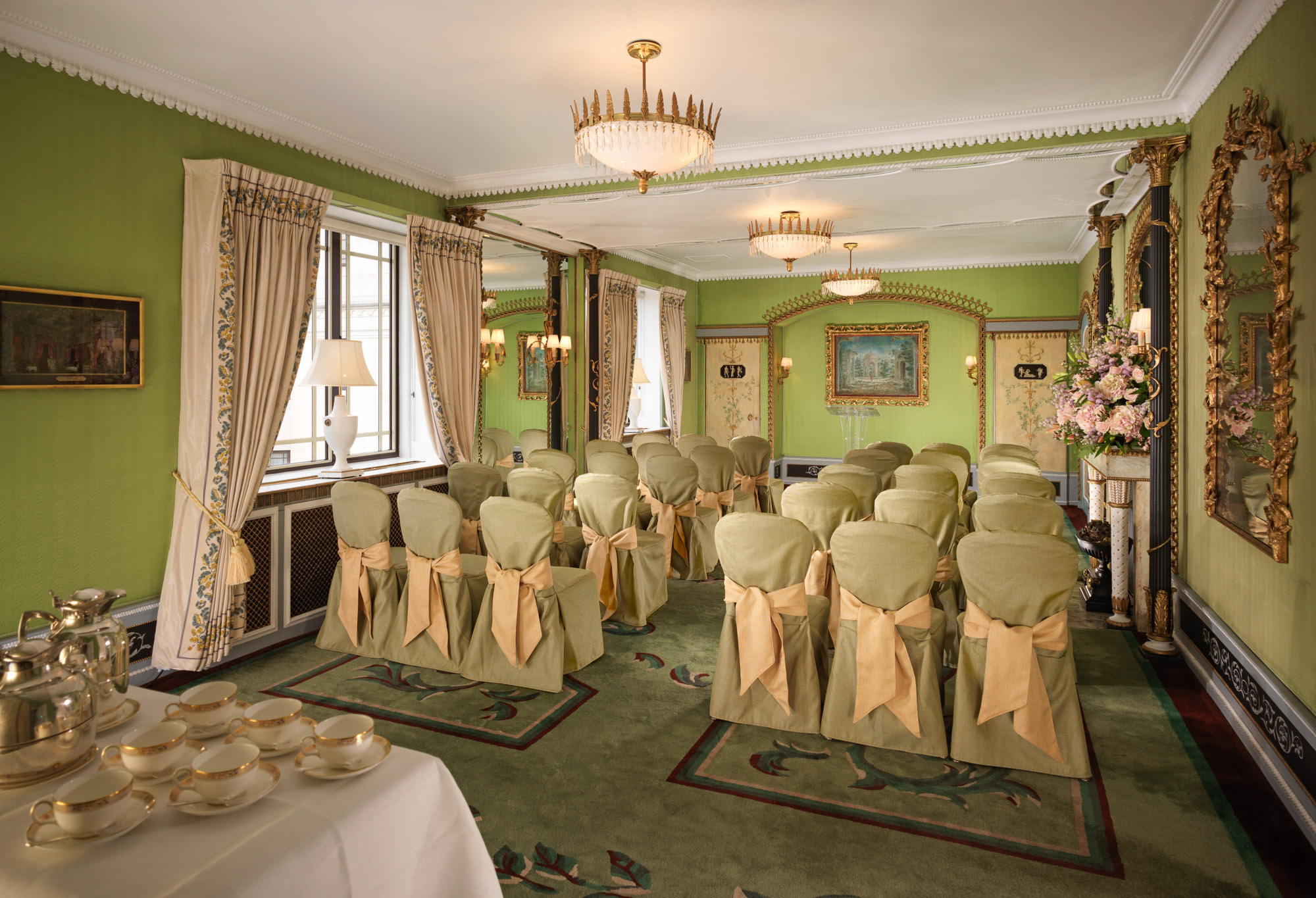 Elegant meeting room in The Dorchester with green walls, ideal for professional gatherings.