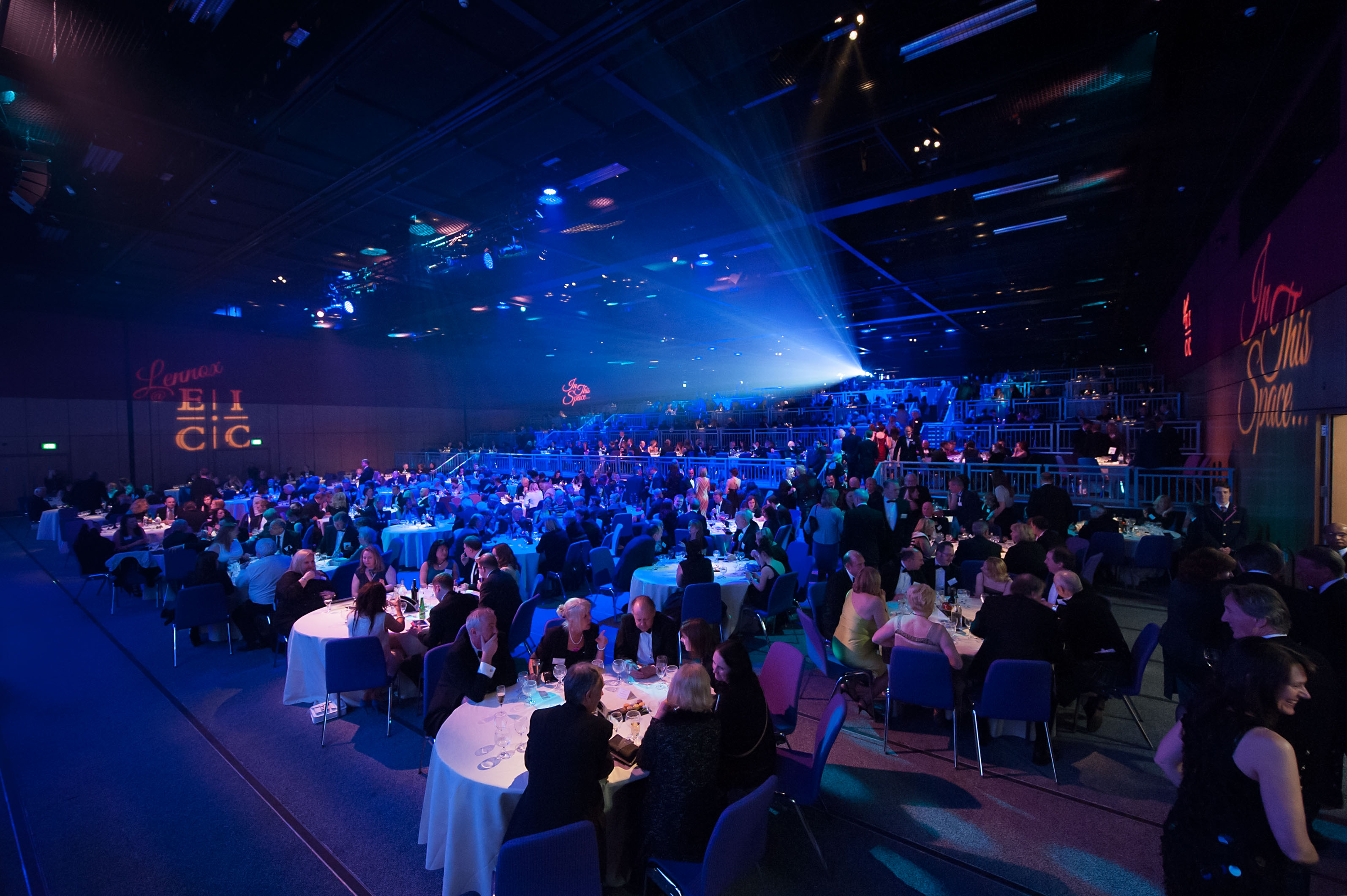 Lennox Suite at Edinburgh Conference Centre, vibrant gala event with elegant tables and dynamic lighting.