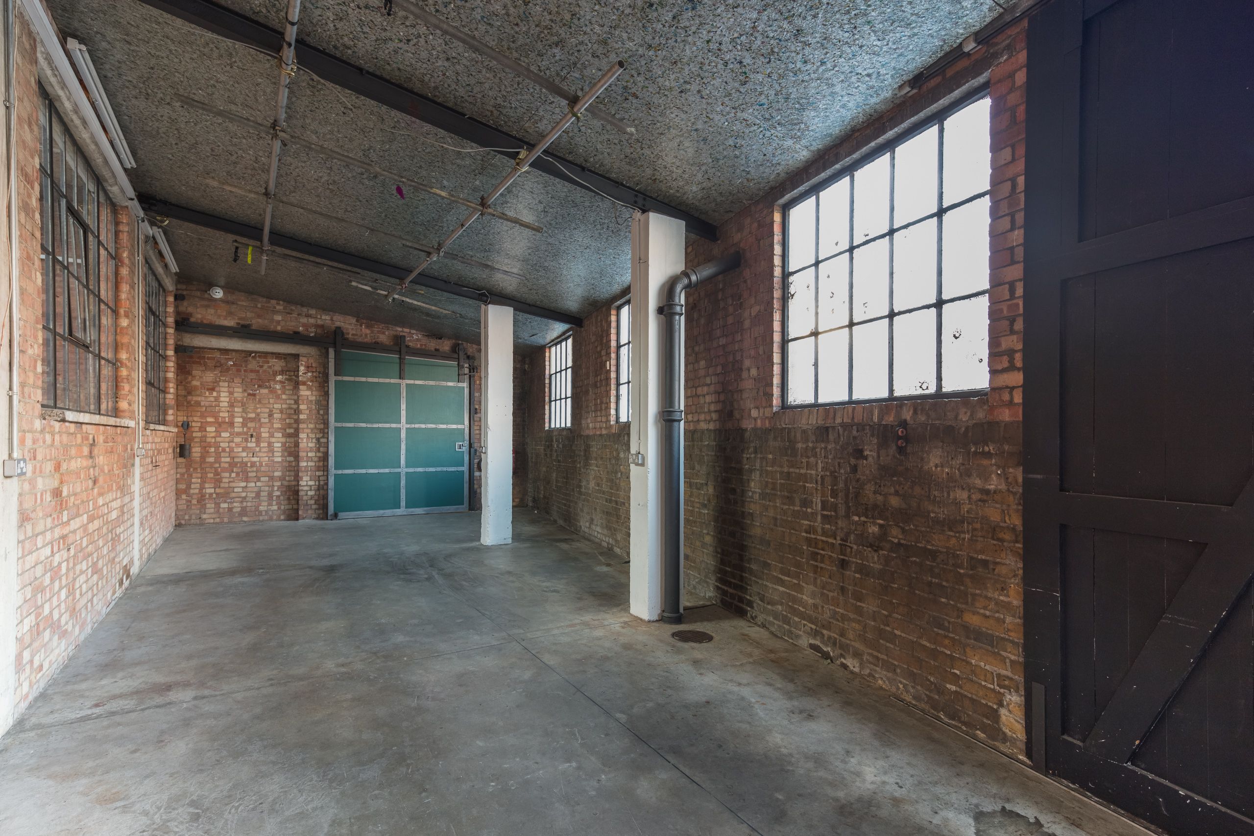 Atrium in Hoxton Docks: industrial venue with exposed brick for events and workshops.