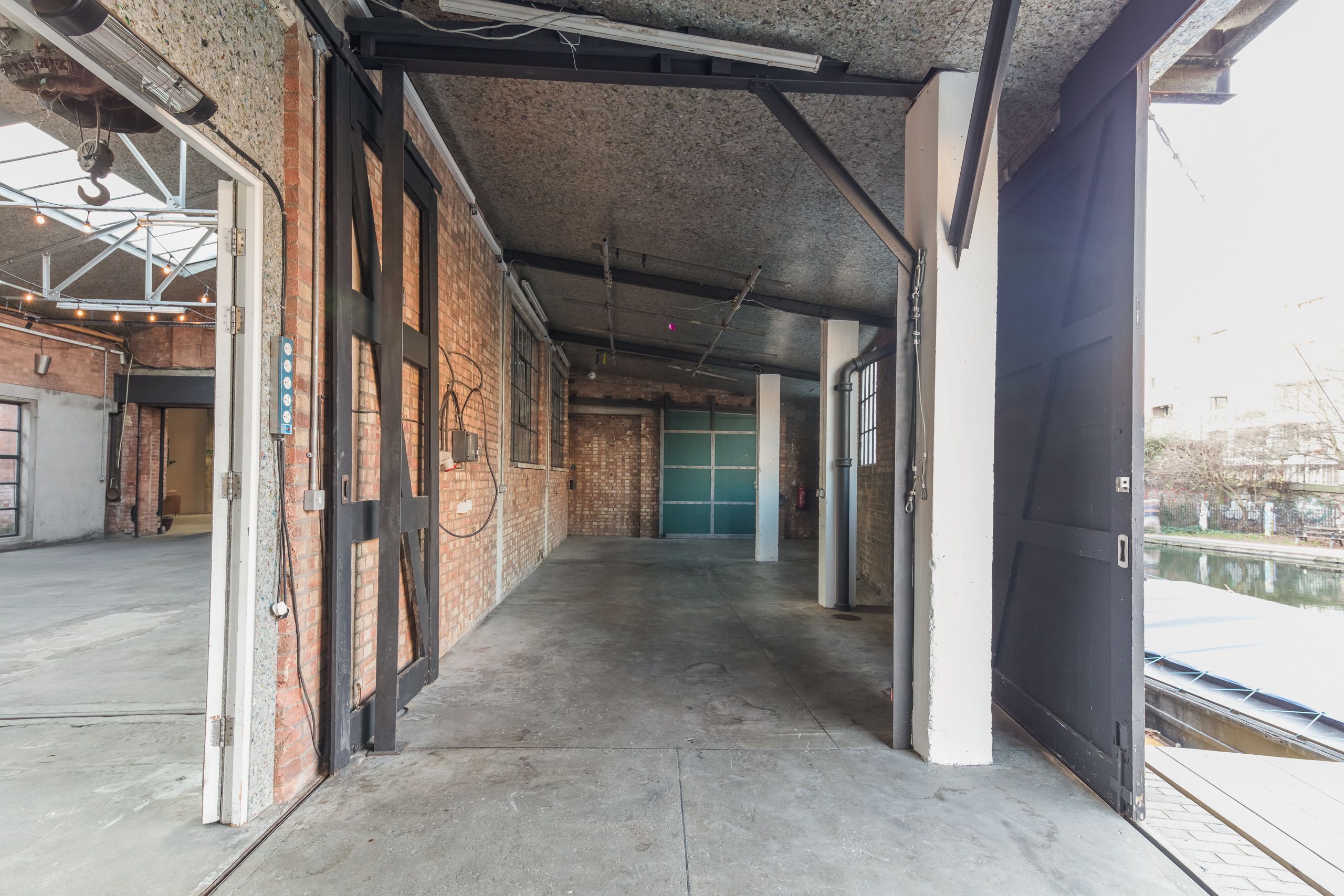 Atrium at Hoxton Docks: industrial event space with exposed brick, ideal for gatherings.