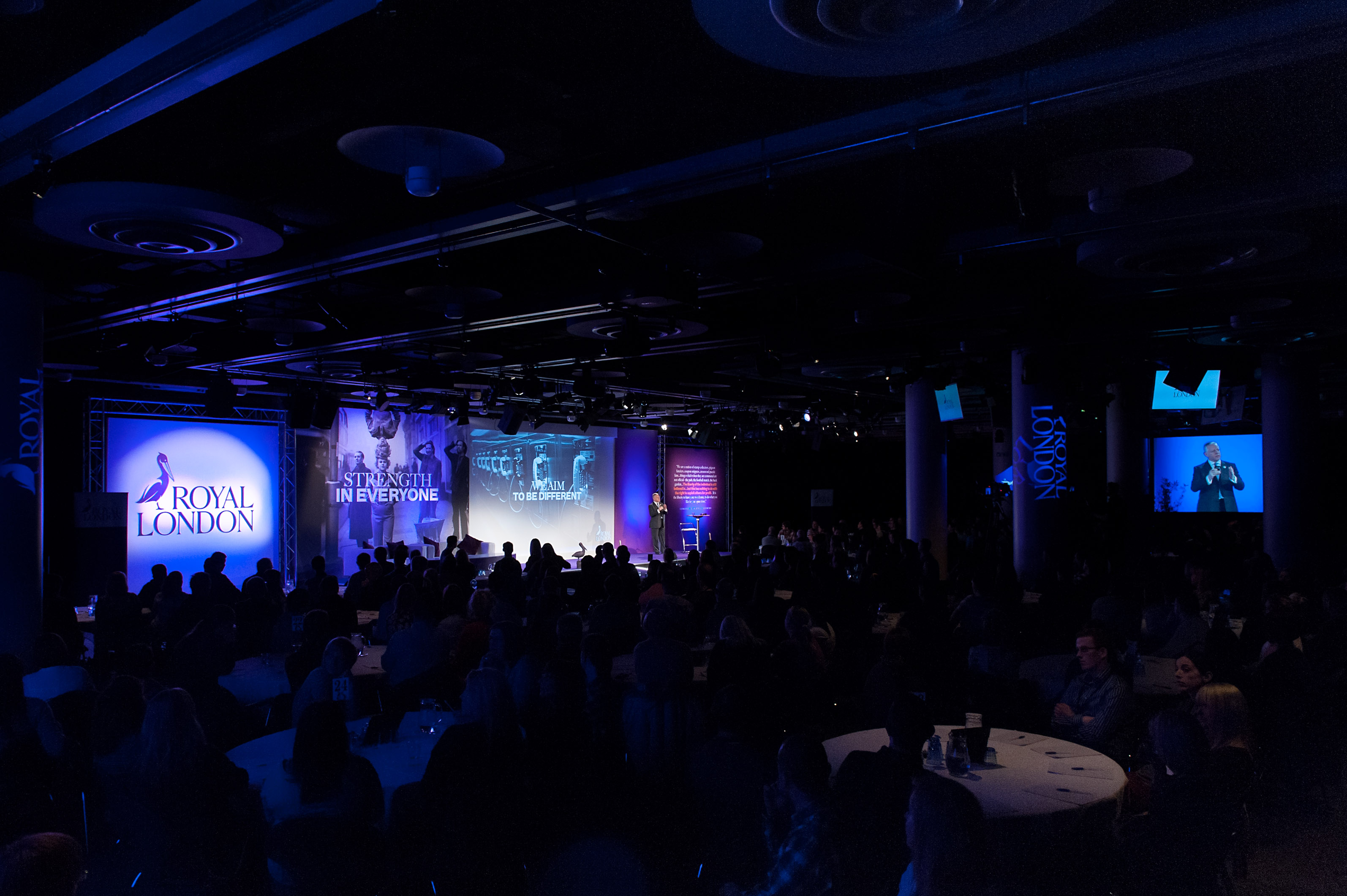 Cromdale Hall conference with dynamic stage and engaged audience in Edinburgh.