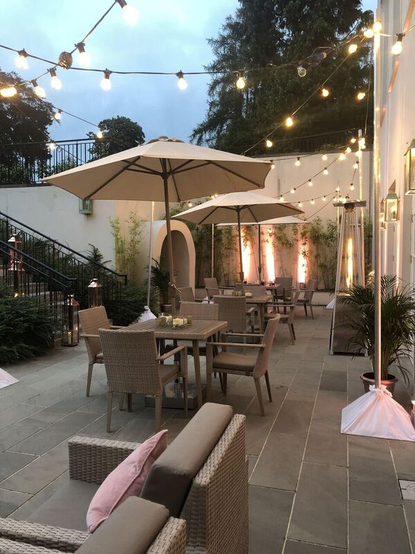 Elegant outdoor event space at Coworth Park with cozy tables and soft lighting.