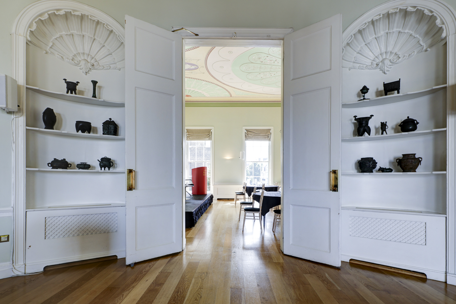 Elegant meeting space in Asia House with ornate double doors and unique artifacts.