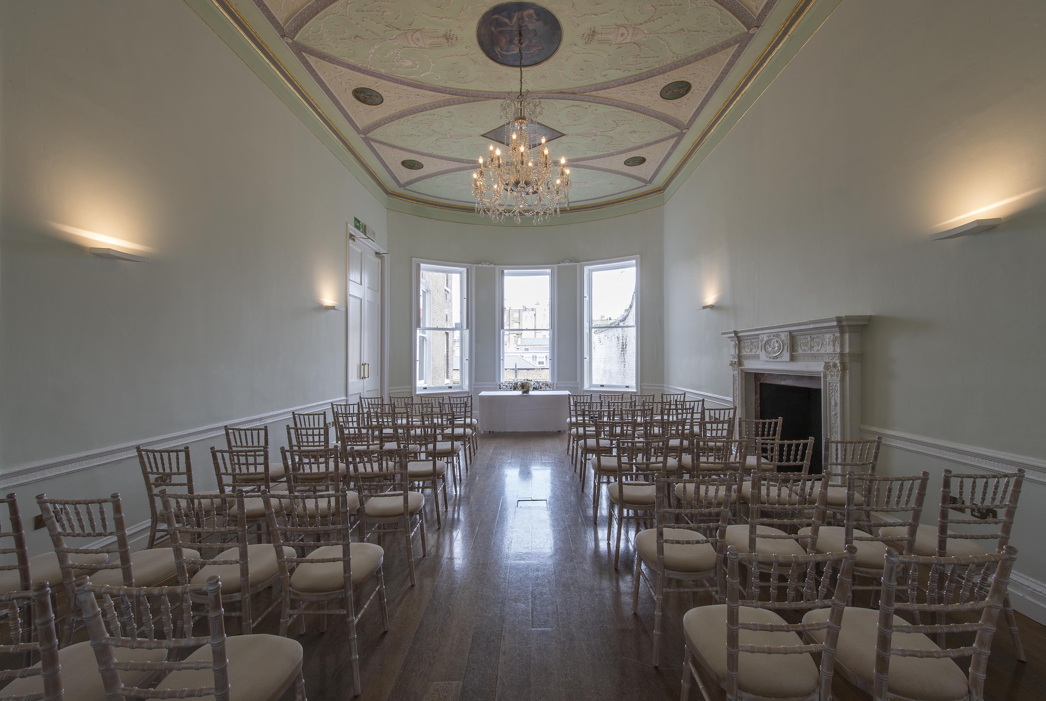Elegant meeting room with chandelier, ideal for corporate events and gatherings.