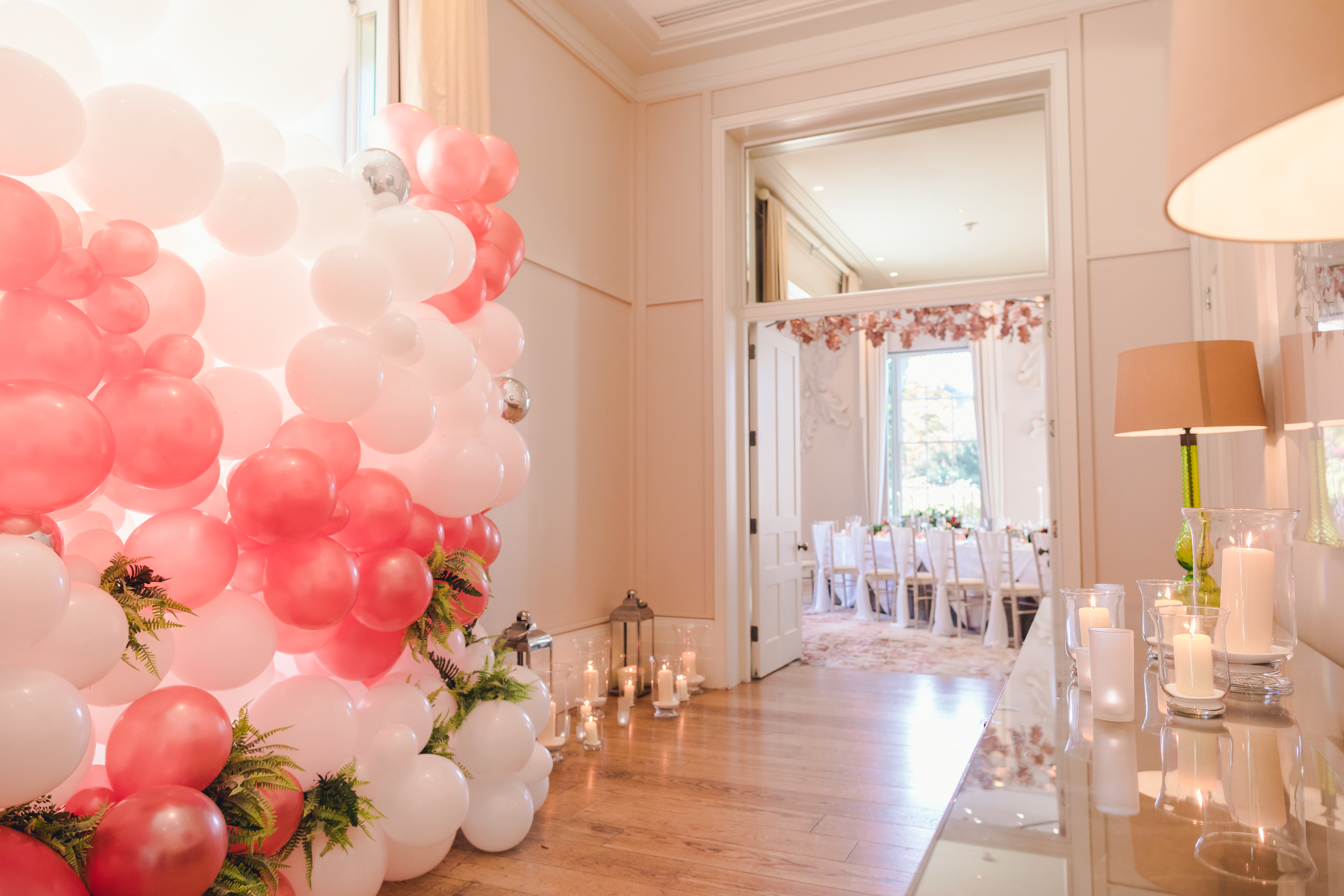 Elegant Oak Room at Coworth Park with pink and white balloon decor for weddings.