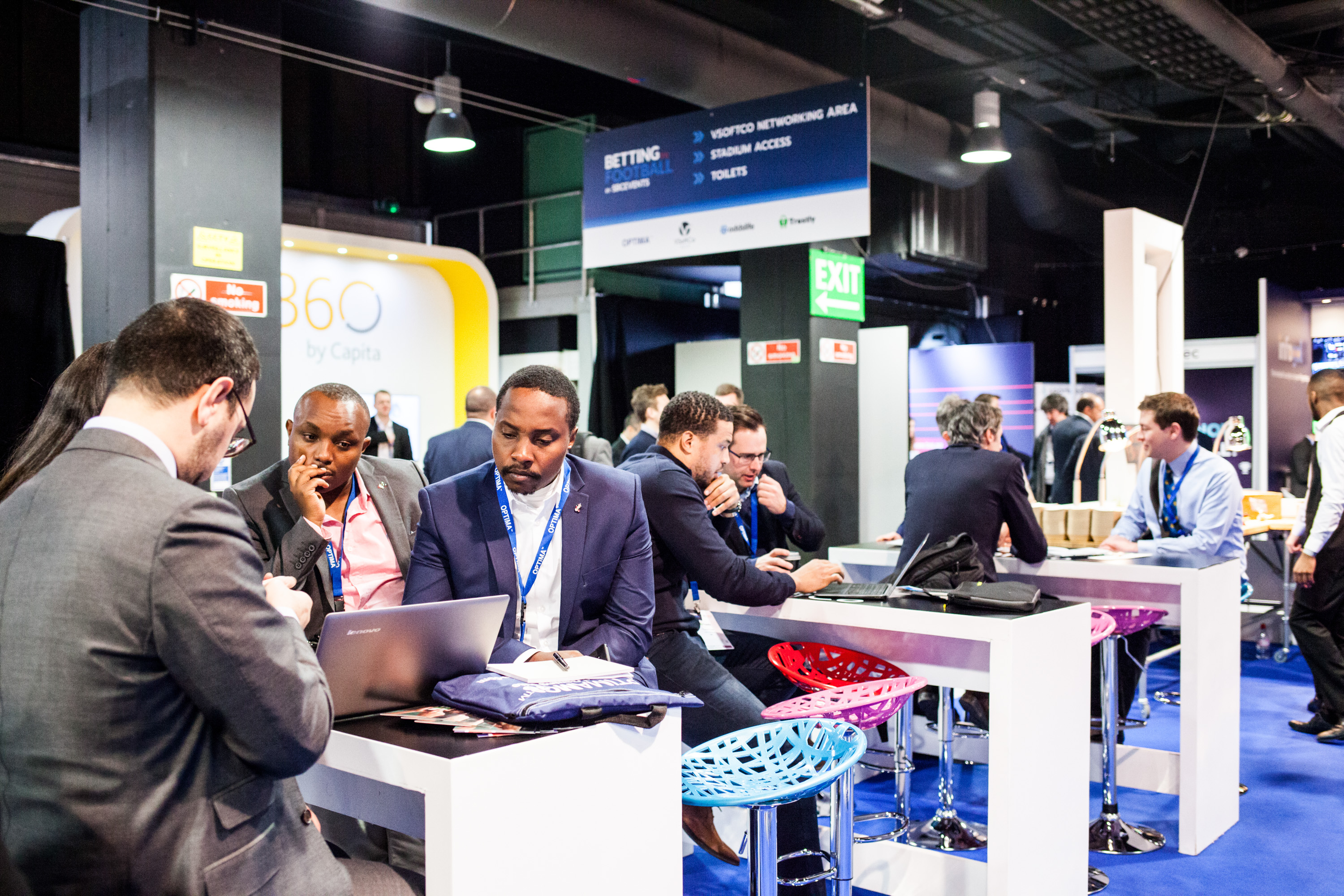 Dynamic networking conference in Chelsea FC's Great Hall with modern seating.