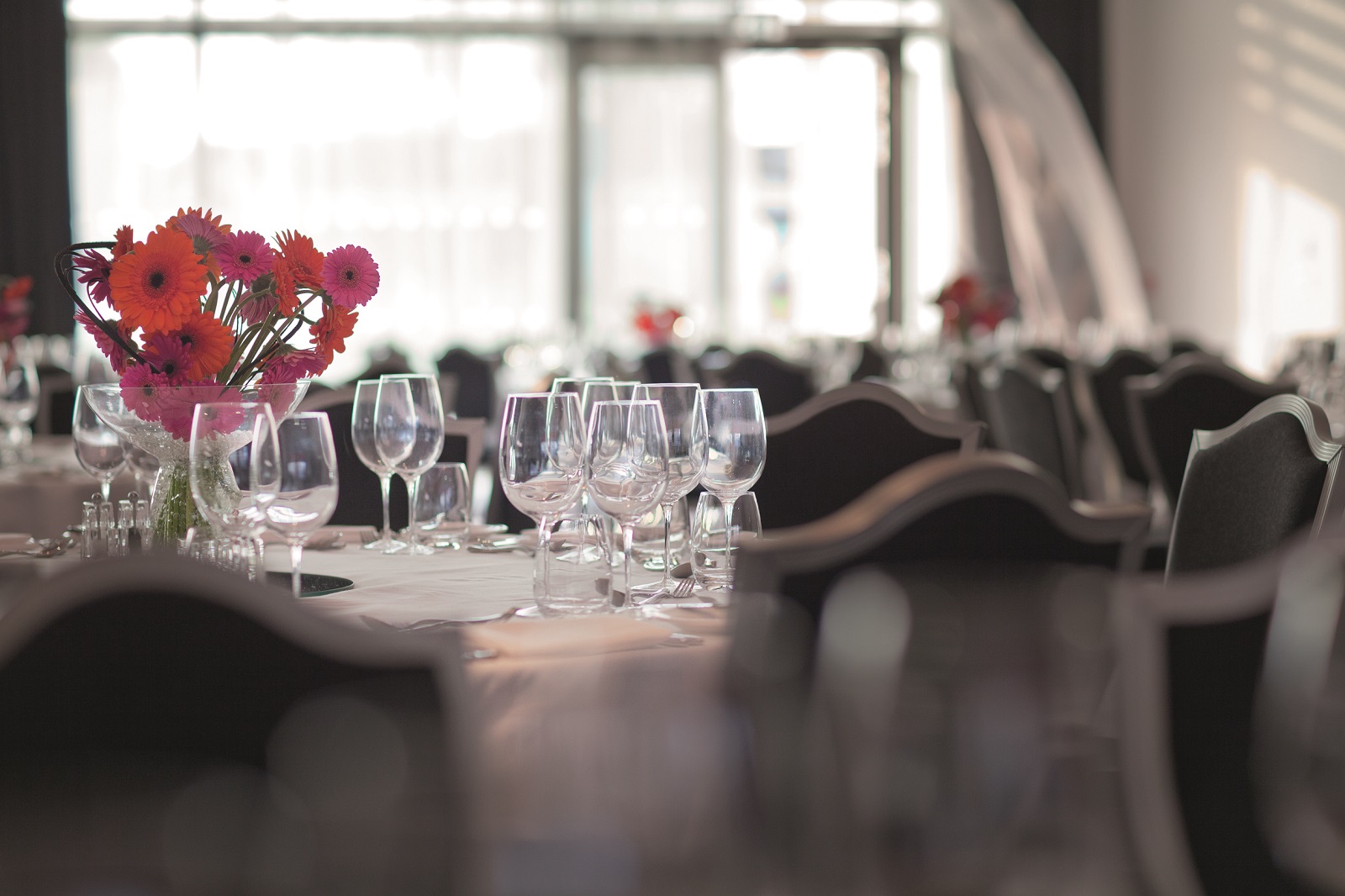 Elegant dining table with vibrant flowers at Grand Syon Ballroom, Hilton London Syon Park.