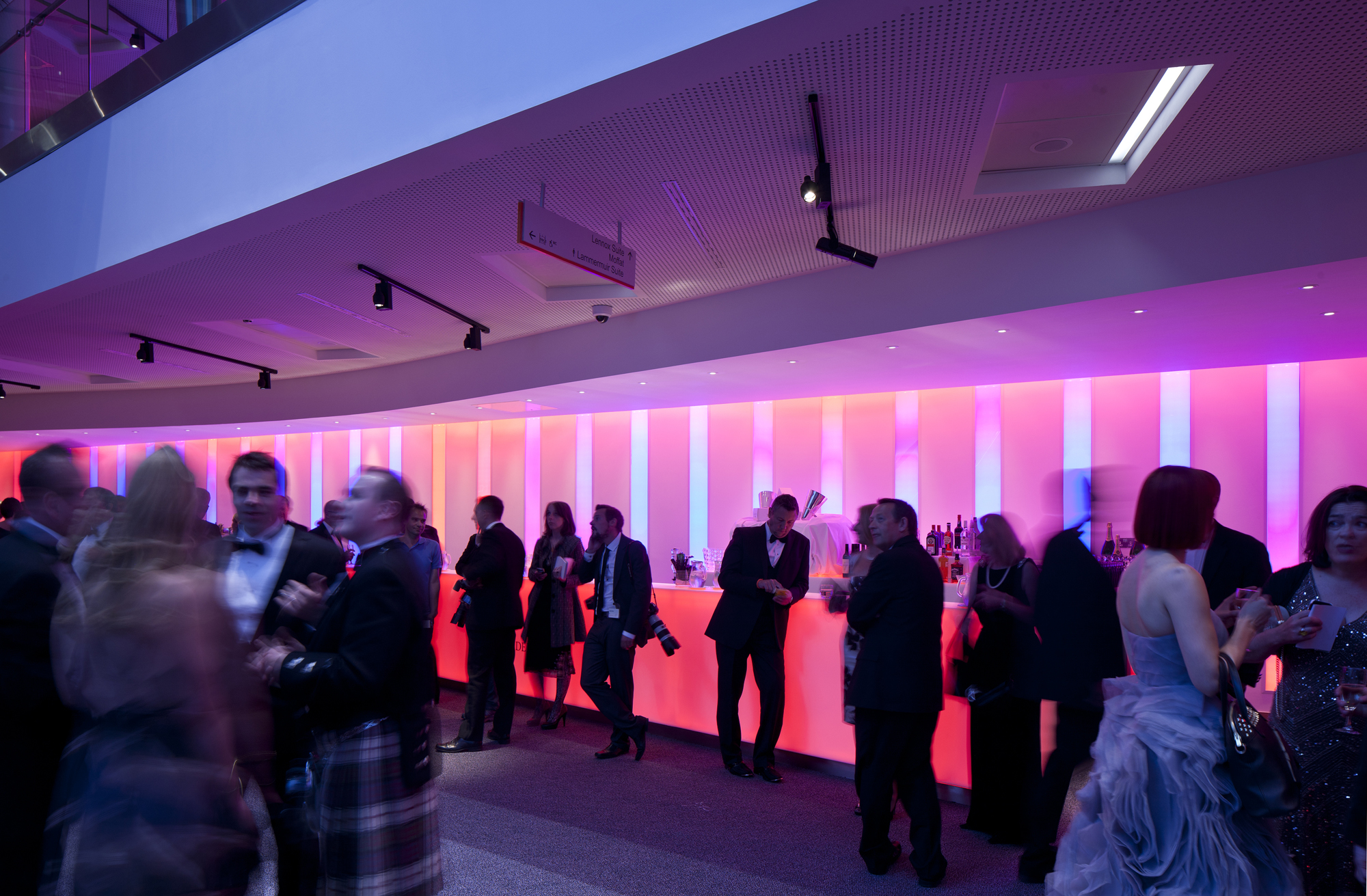 Atrium at Edinburgh International Conference Centre with vibrant pink lighting for networking events.