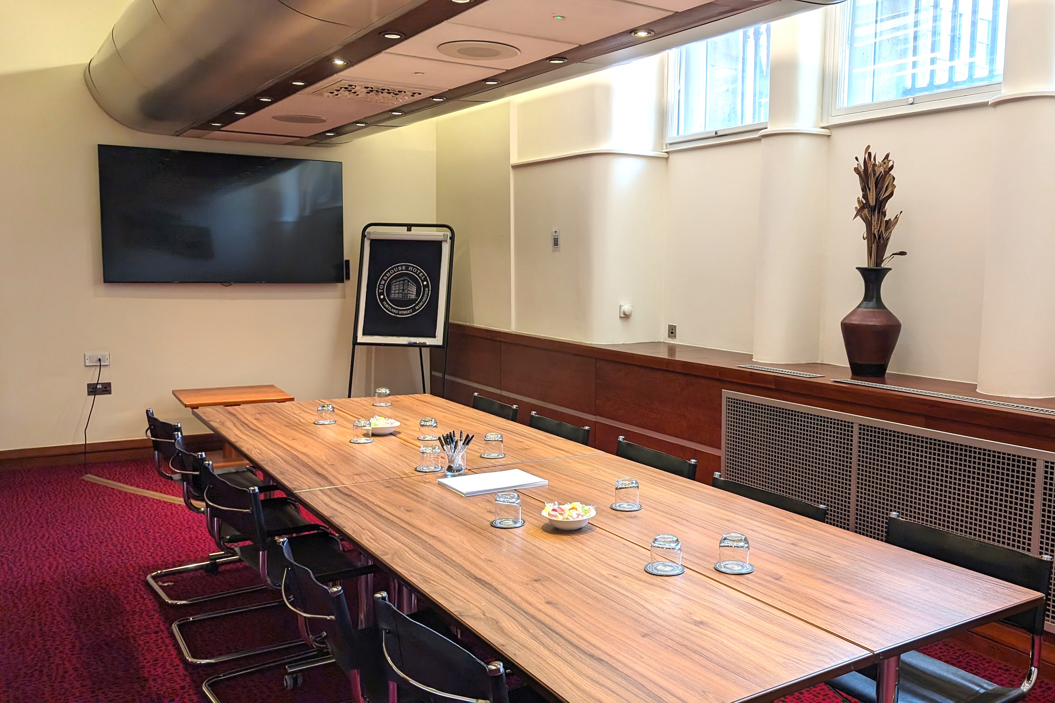 Portland Room at Townhouse Hotel: elegant meeting space with wooden table for professional events.