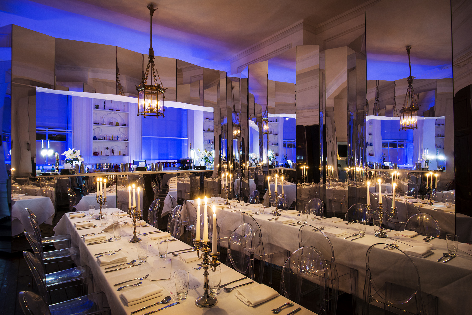 Laurie Landeau in elegant event space with blue lighting for upscale dinners and corporate events.