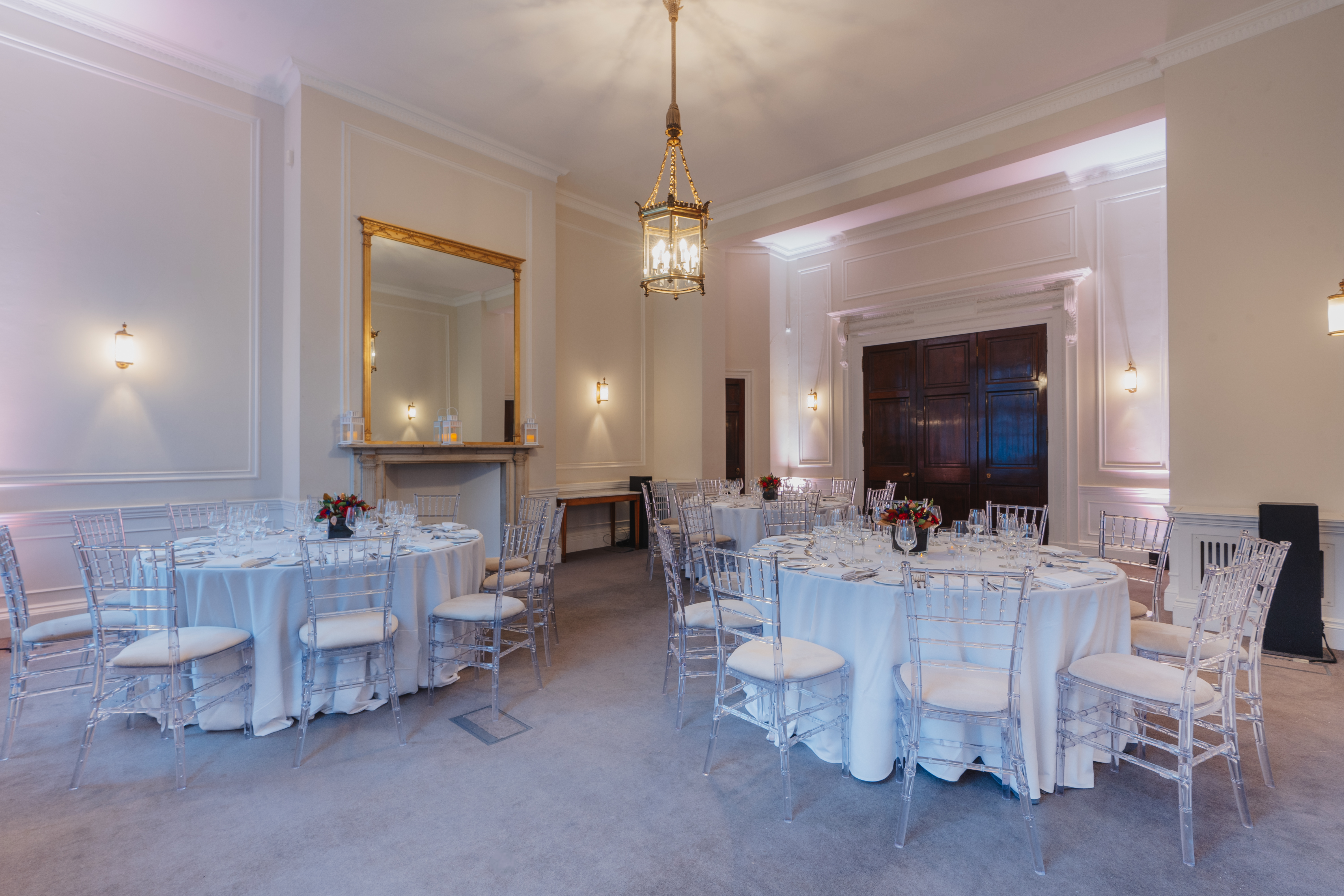 Laurie Landeau in elegant event space with round tables for upscale meetings and celebrations.