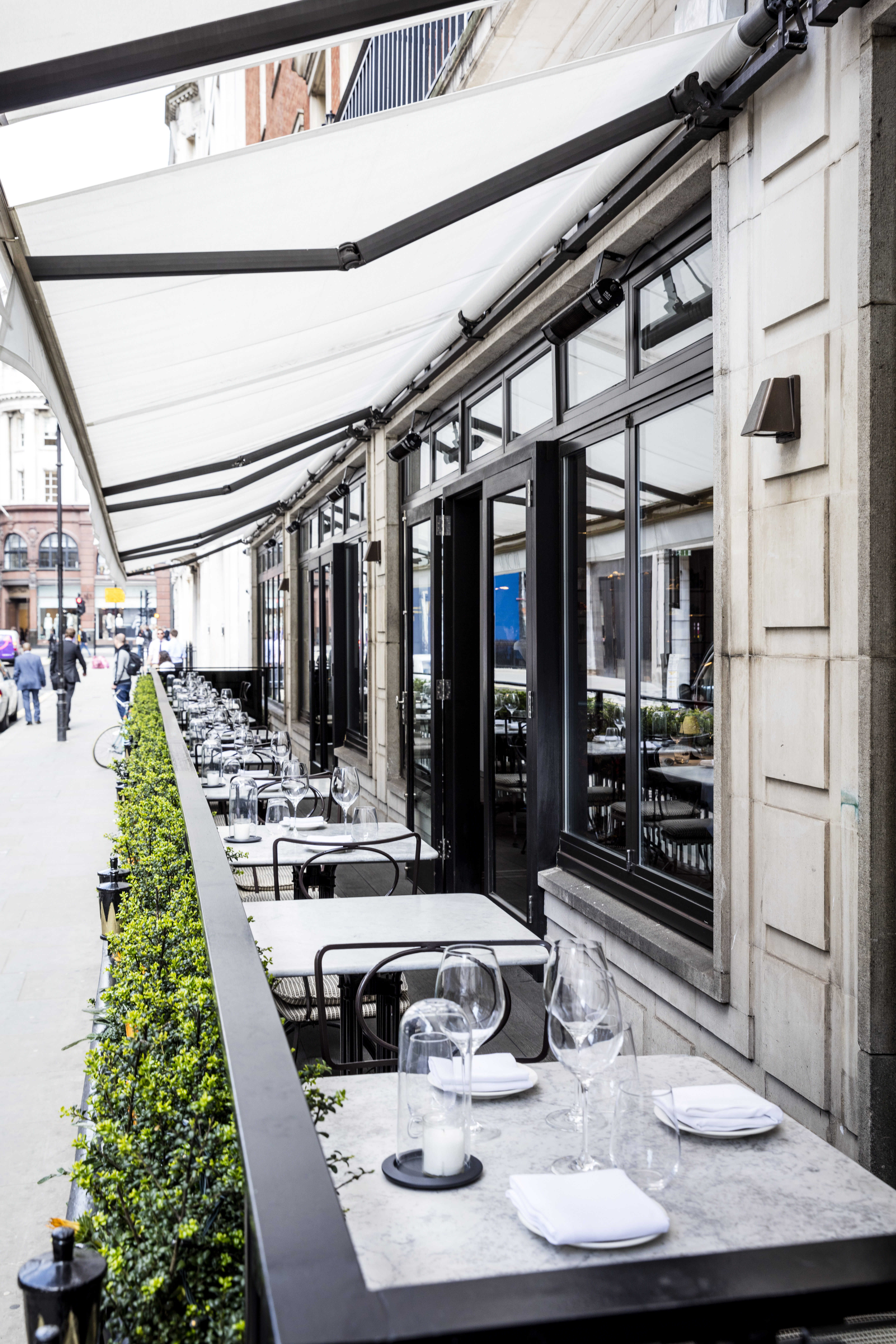 Stylish outdoor dining area at Sartoria, perfect for casual meetings and networking events.