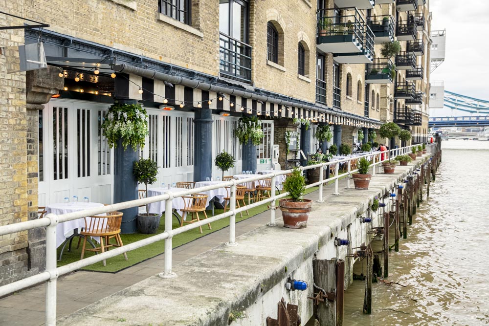 Charming waterfront venue at Butlers Wharf for outdoor events with elegant seating.