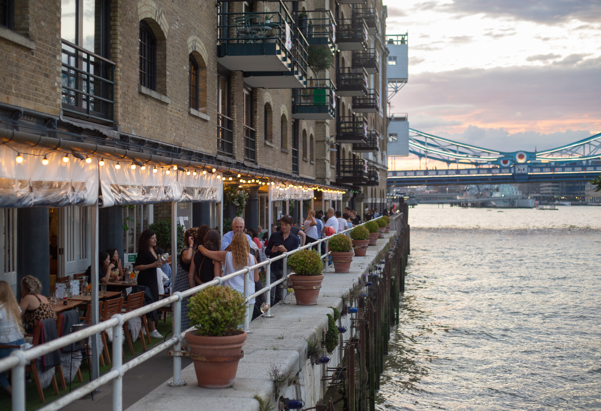 Vibrant waterfront venue at Butlers Wharf, ideal for events with lush greenery and charm.