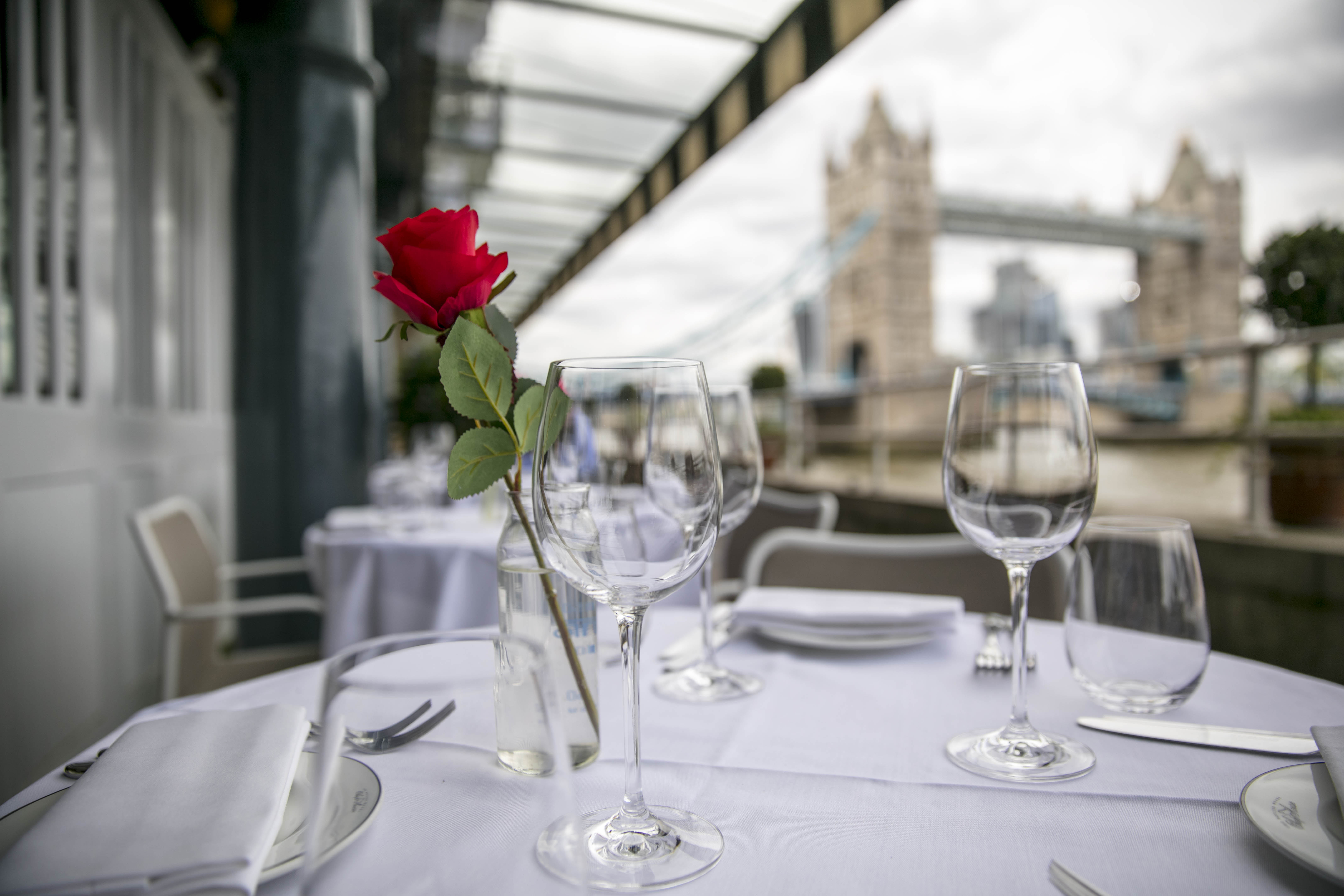 Elegant table with red rose centerpiece at Butlers Wharf Chop House, ideal for events.