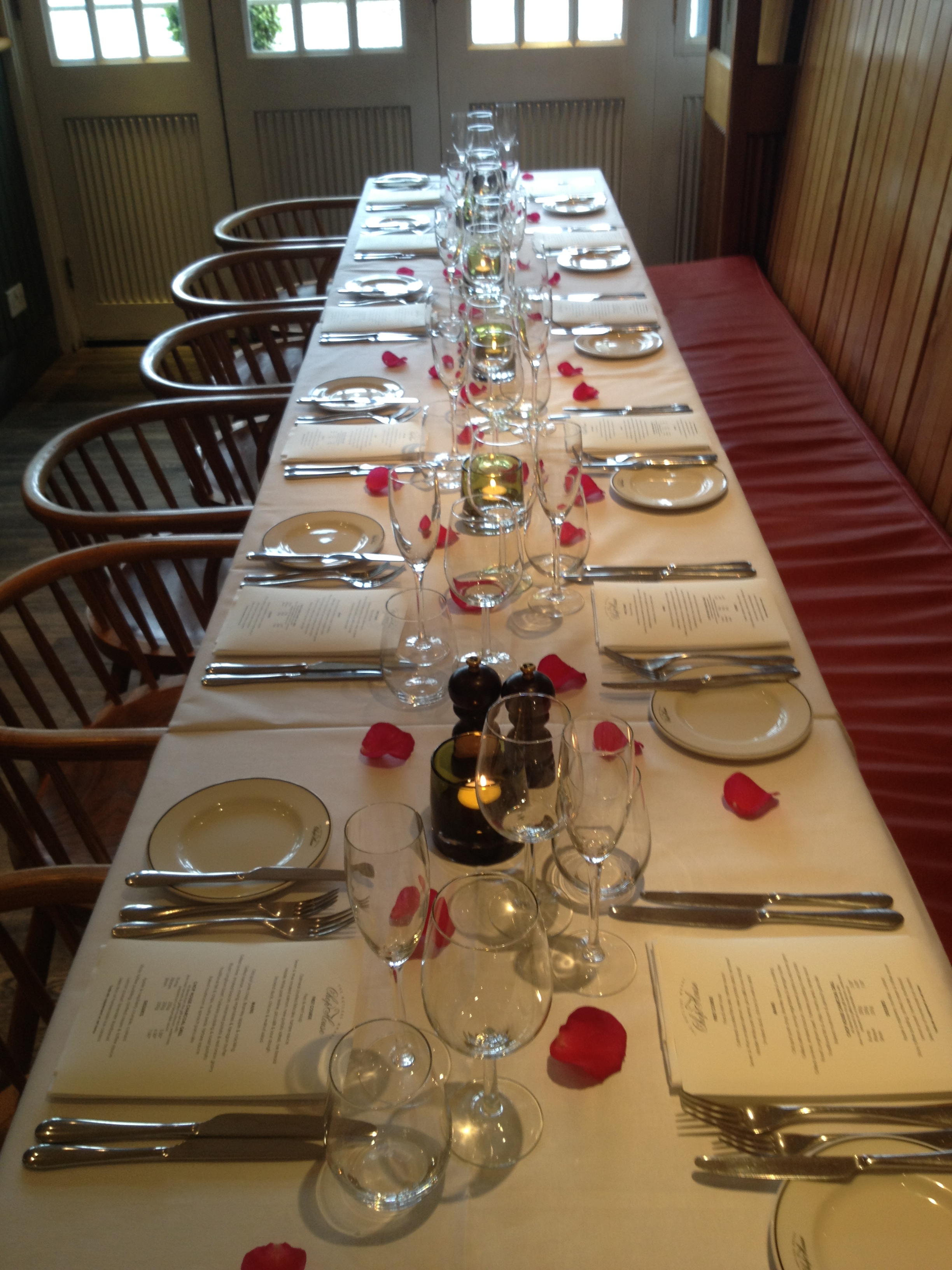 Elegant dining table with rose petals at Butlers Wharf Chop House for special occasions.