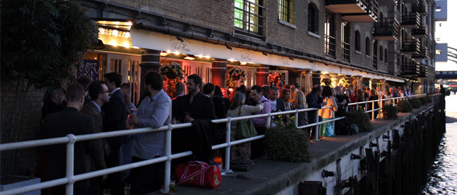 Outdoor networking event at Butlers Wharf Chop House with vibrant ambiance and waterfront views.