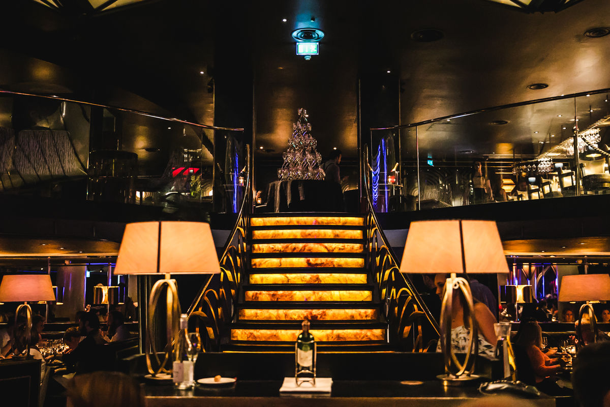 Sophisticated Quaglino's venue with elegant lighting and striking staircase for upscale events.
