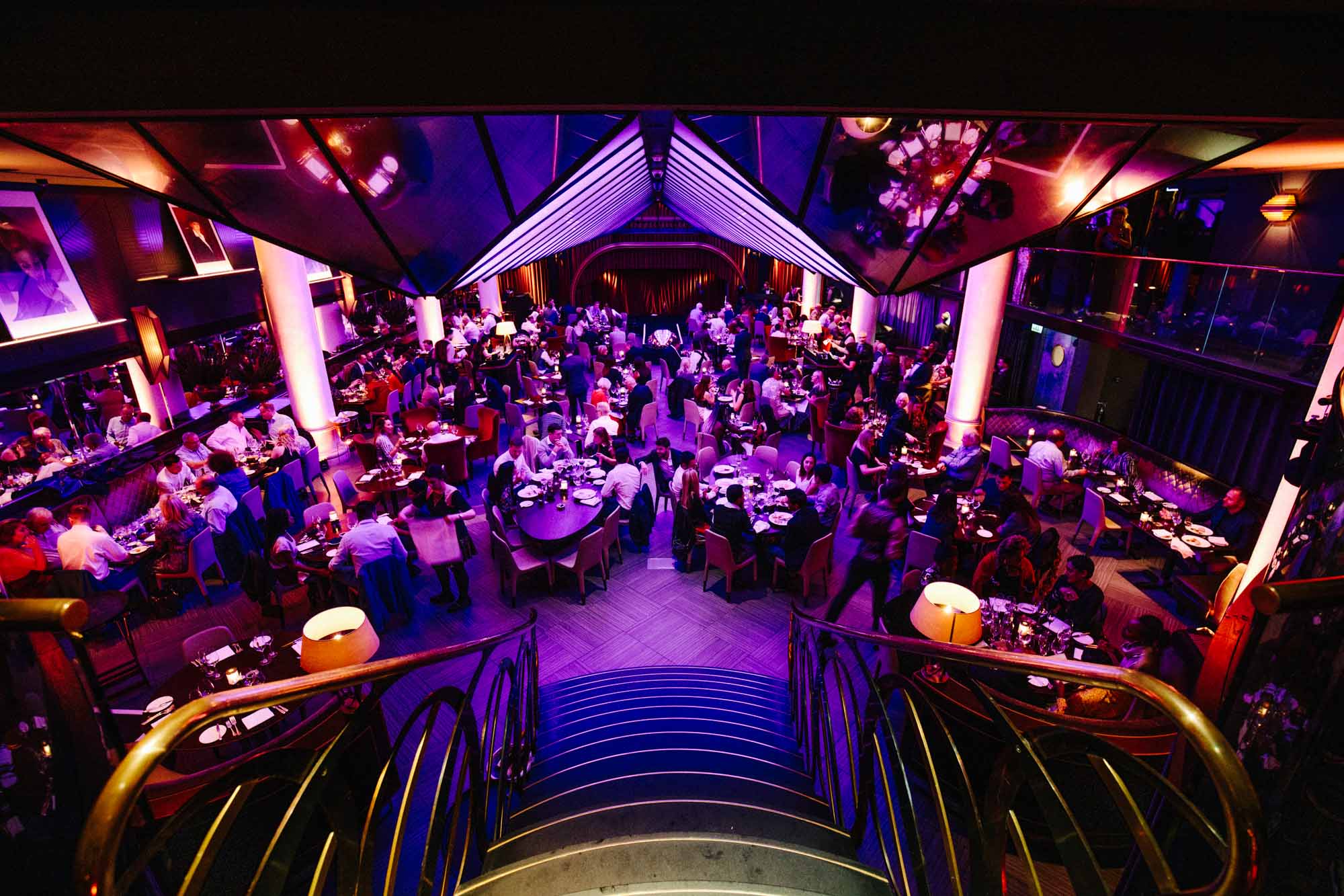 Vibrant Quaglino's venue with purple lighting, ideal for large celebrations and events.