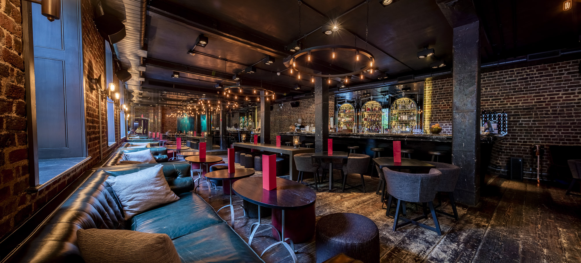 Stylish event space in Old Bengal Bar with exposed brick, ideal for networking and receptions.