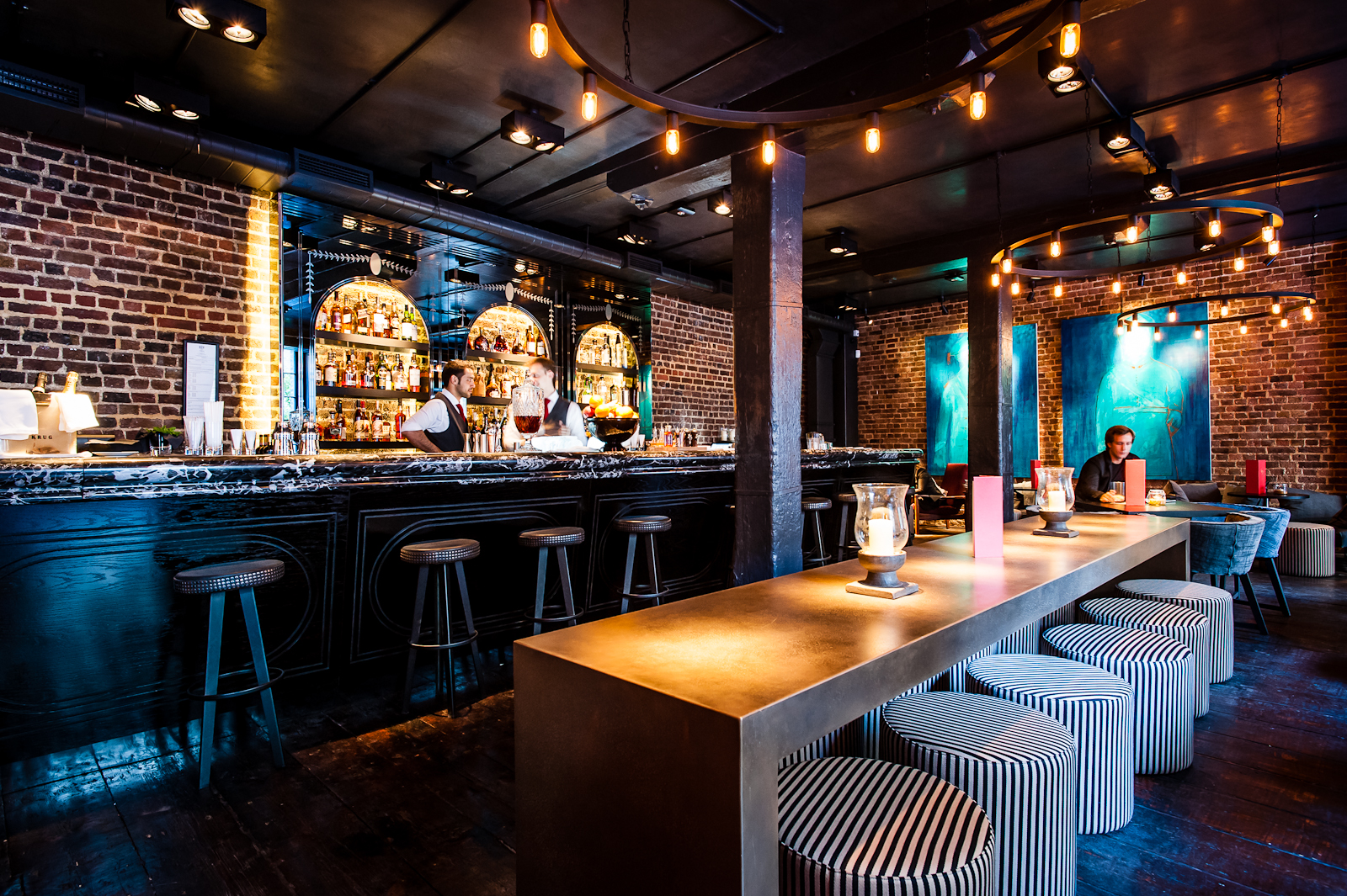 Stylish bar with exposed brick, perfect for networking events and cocktail receptions.