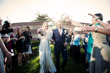 Joyful wedding celebration at Coq d'Argent with confetti and smiling guests.