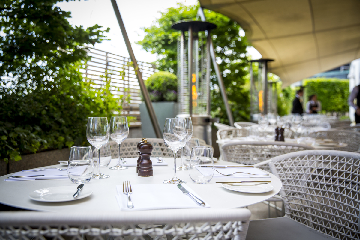 Elegant outdoor dining at Bar Terrace, Coq d'Argent for upscale events and gatherings.