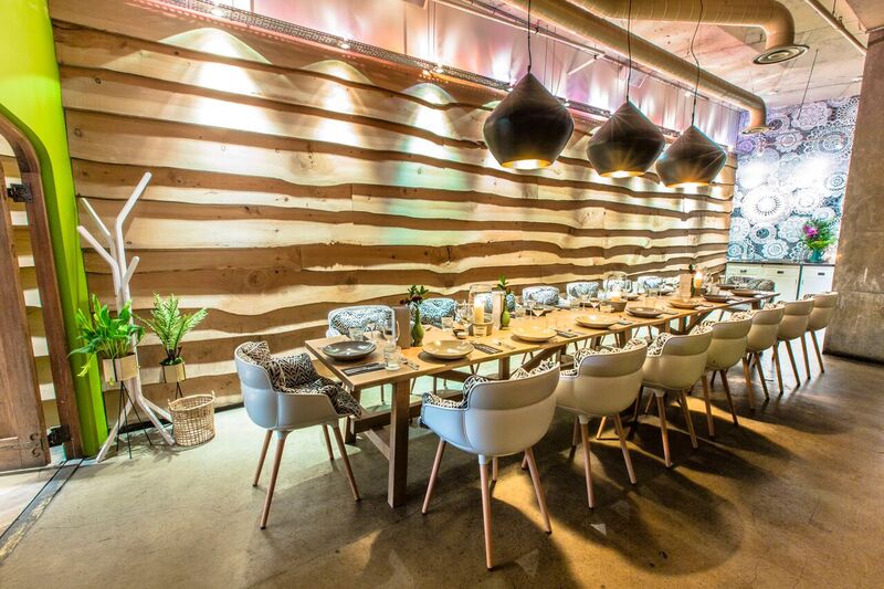 Private room at The Folly Bar with rustic wooden wall, ideal for intimate dinners and events.