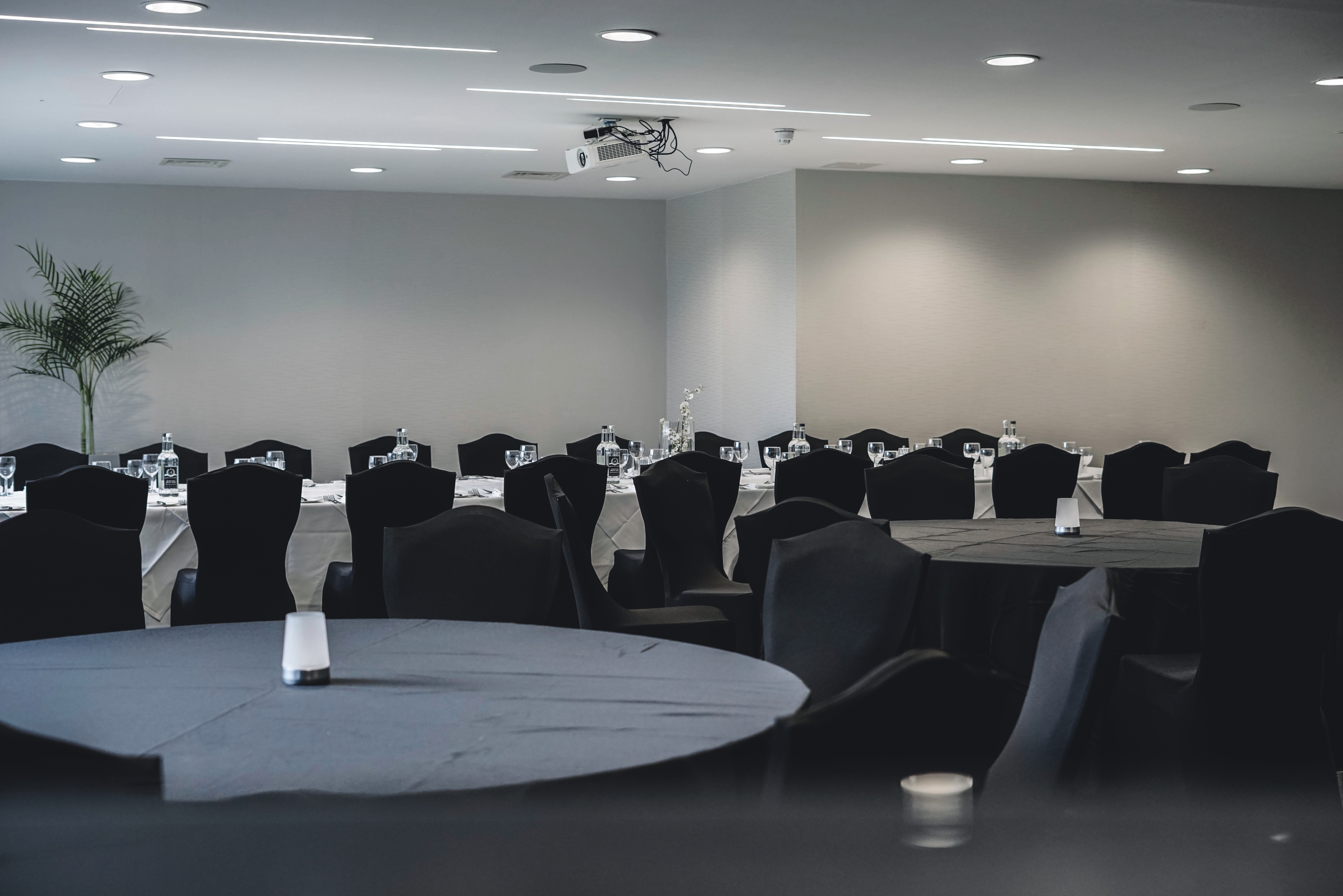Event space at Dukes, Hilton London Syon Park, featuring elegant black table settings.