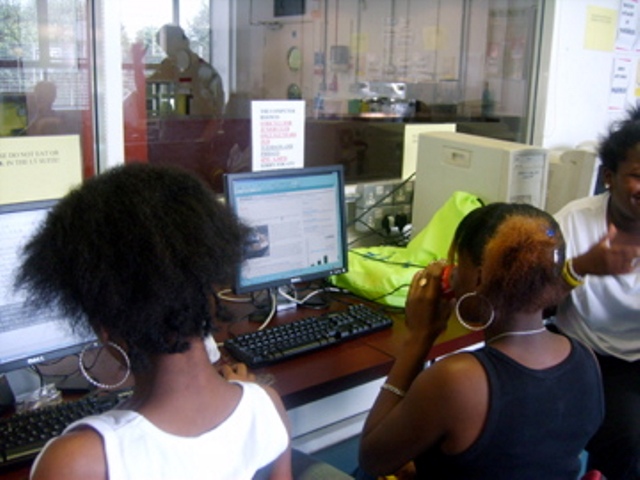 Young individuals collaborating in The Harrow Club I.T. Suite for events and teamwork.