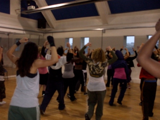 Dynamic group fitness class in a bright dance studio for wellness events and team-building.