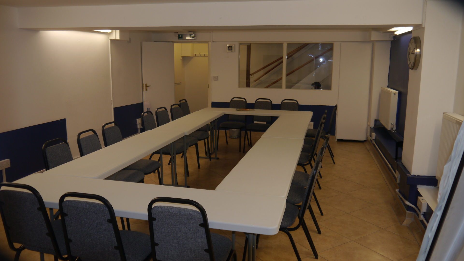 Versatile meeting room with U-shaped table for collaborative discussions and presentations.