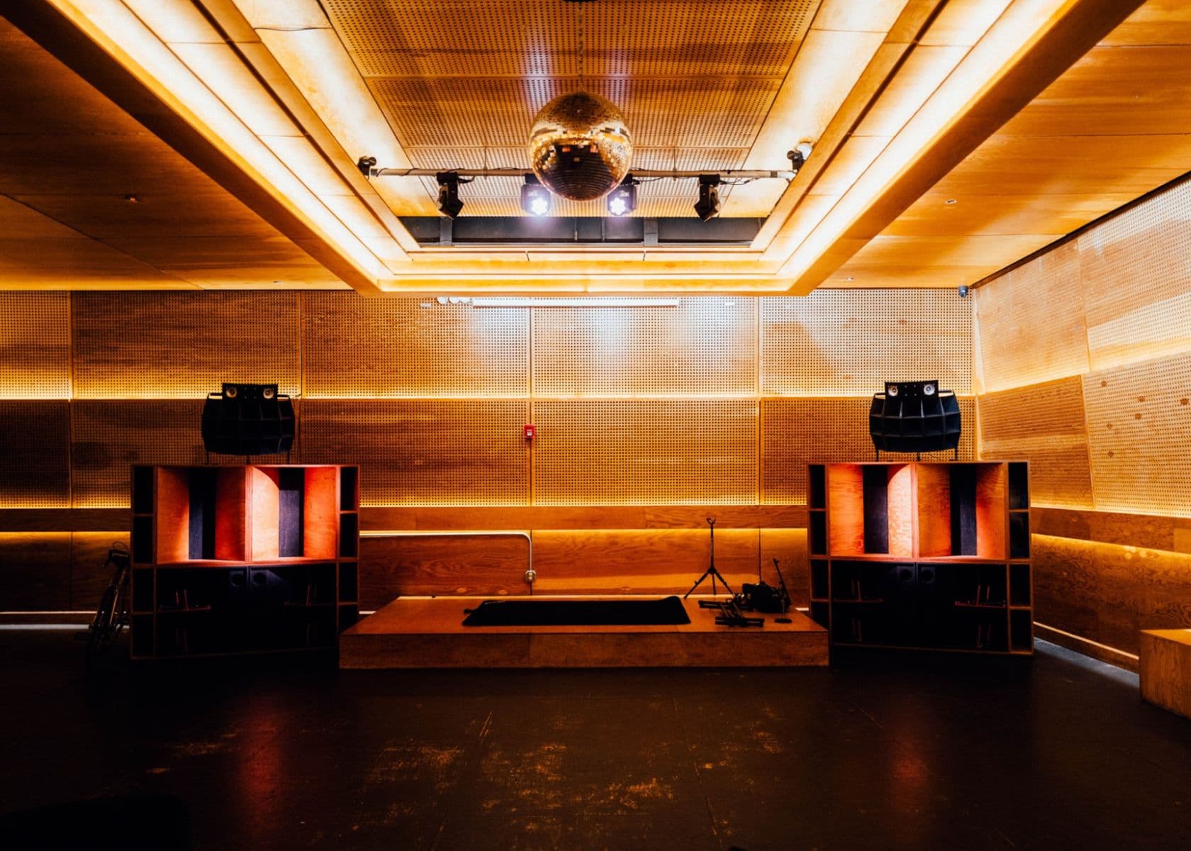 The Speakeasy venue stage with ambient lighting for corporate events and music showcases.
