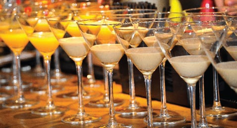 Elegant cocktail display in martini glasses at Primrose Bar for event catering.