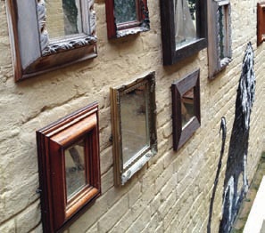 Banksy Beer Garden wall with vintage frames, ideal for creative events and gatherings.