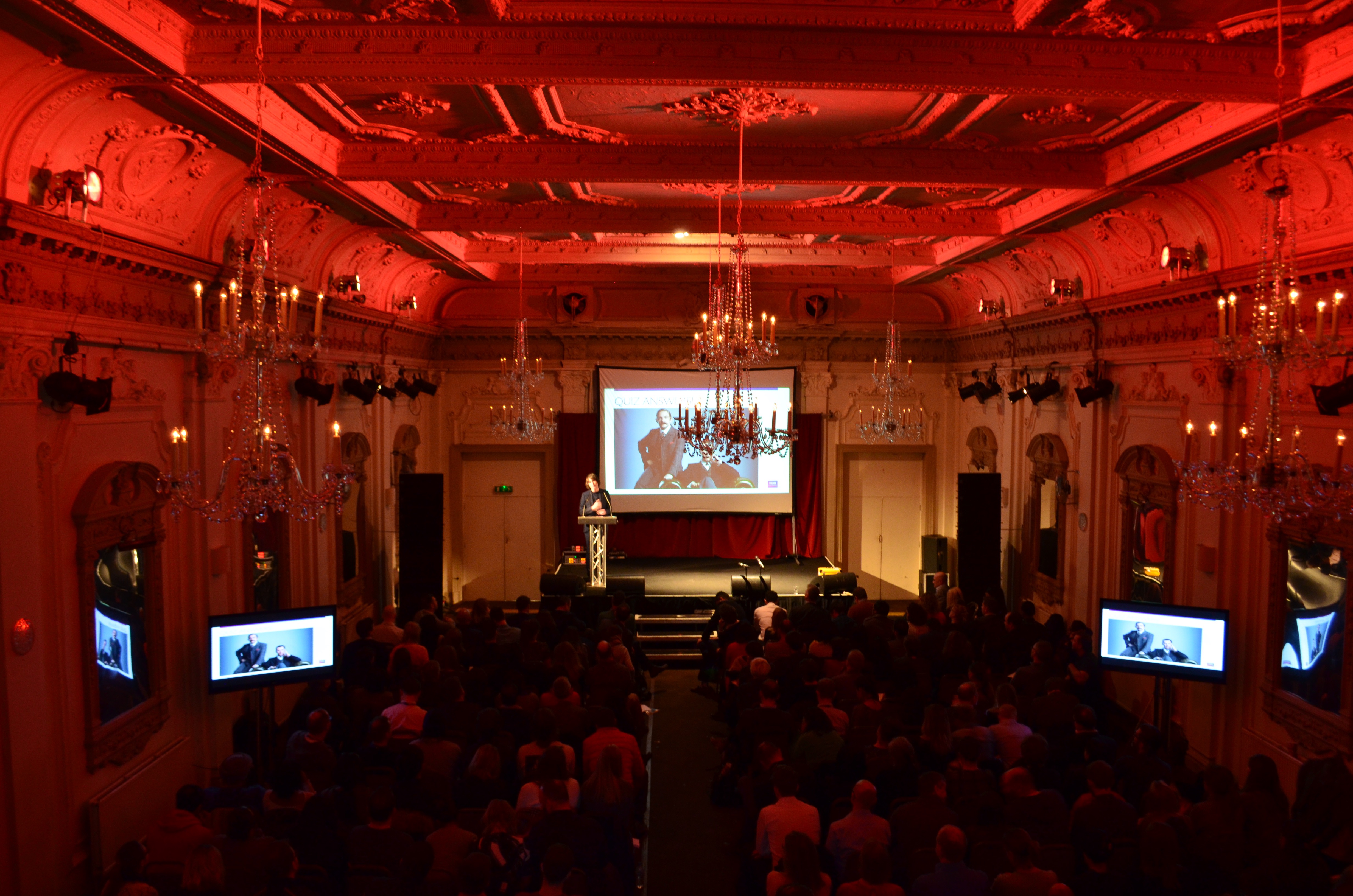 Whole Venue in Bush Hall: elegant event space with red lighting for presentations and networking.